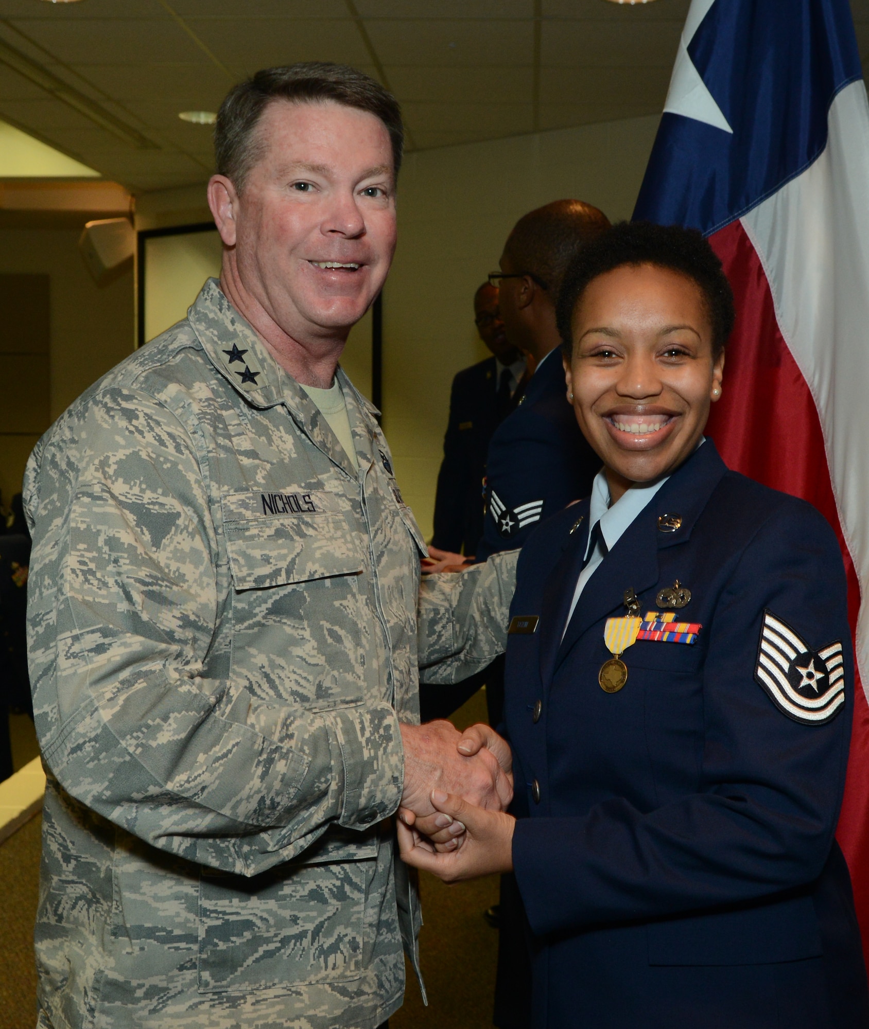 Major Gen. John Nichols, Adjutant General for the State of Texas congratulates Tech. Sgt. Carolyn Tatum, 136th Air Lift Wing, Non Commissioned Officer of the Year for Texas, at Camp Mabry, Jan.13, 2013. Tatum continues on for the State in the national competition, competing against active duty Air Force and Reserves. (National Guard photo by Senior Master Sgt. Elizabeth Gilbert)