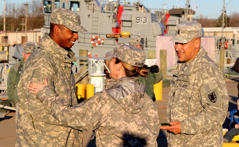 (From left) U.S. Army Sgt. Eddie Partee, an information technology specialist assigned to the Headquarters and Headquarters Company, 10th Transportation Battalion, 7th Sustainment Brigade, receives the Army Commendation Medal from Col. Jennifer Reinkober, the 7th Sus. Bde commander, and Command Sgt. Maj. Tony Escalona, the brigade's command sergeant major, during a ceremony at Fort Eustis, Va., Jan. 4, 2013. Partee received the medal for earning the title of 2012 7th Sus. Bde. Noncommissioned Officer of the Year. (U.S. Army photo by Sgt. Edwin Rodriguez/Released) 
