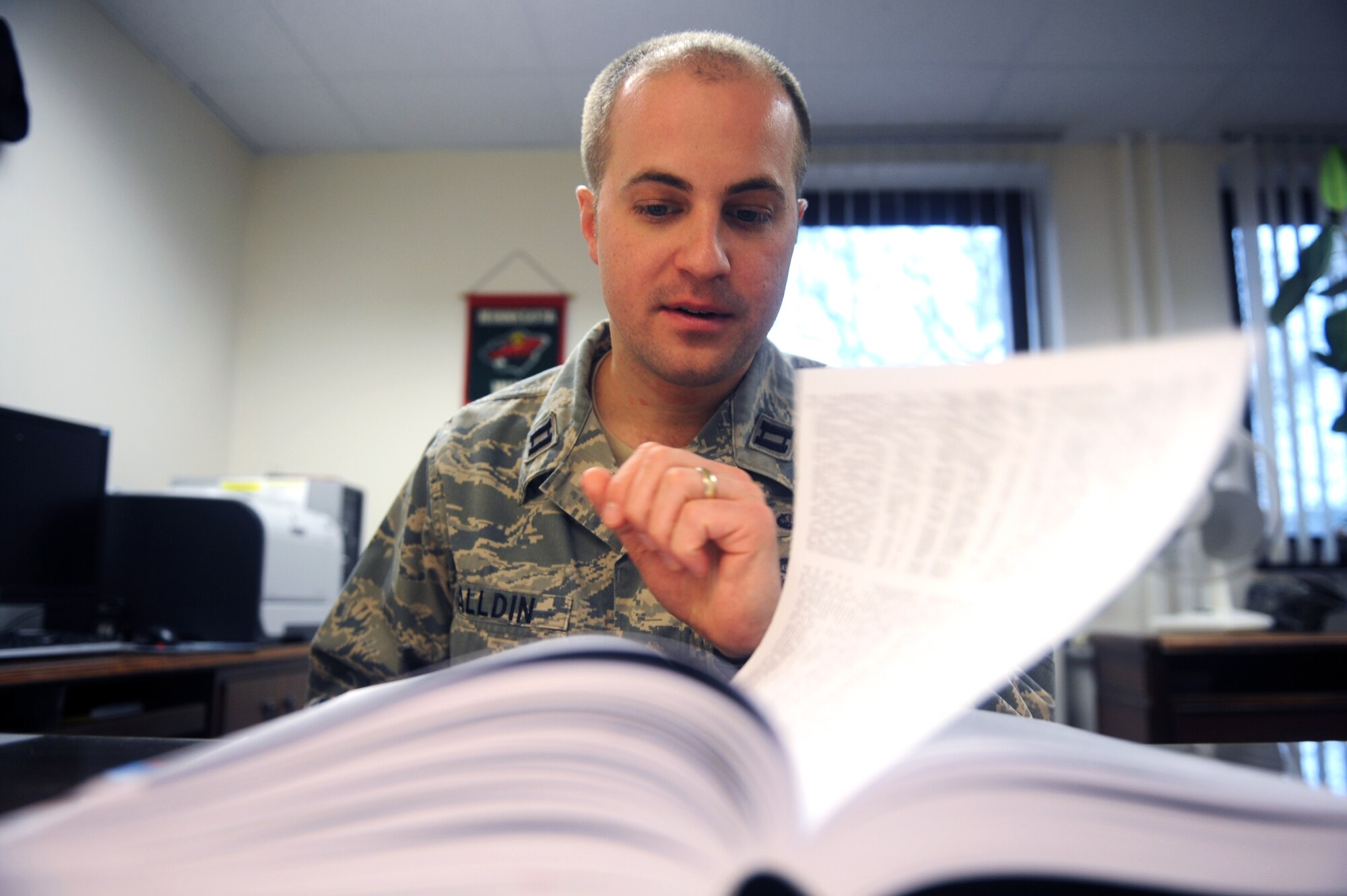 Capt. Andrew Halldin, Area Defense Counsel attorney, researches articles for a case at Ramstein Air Base, Germany, Jan. 10, 2013. The Ramstein Area defense counsel is here to help Airmen who face courts-martial charges, non-judicial punishment and various administrative actions. (U.S. Air Force photo/ Senior Airman Aaron-Forrest Wainwright)