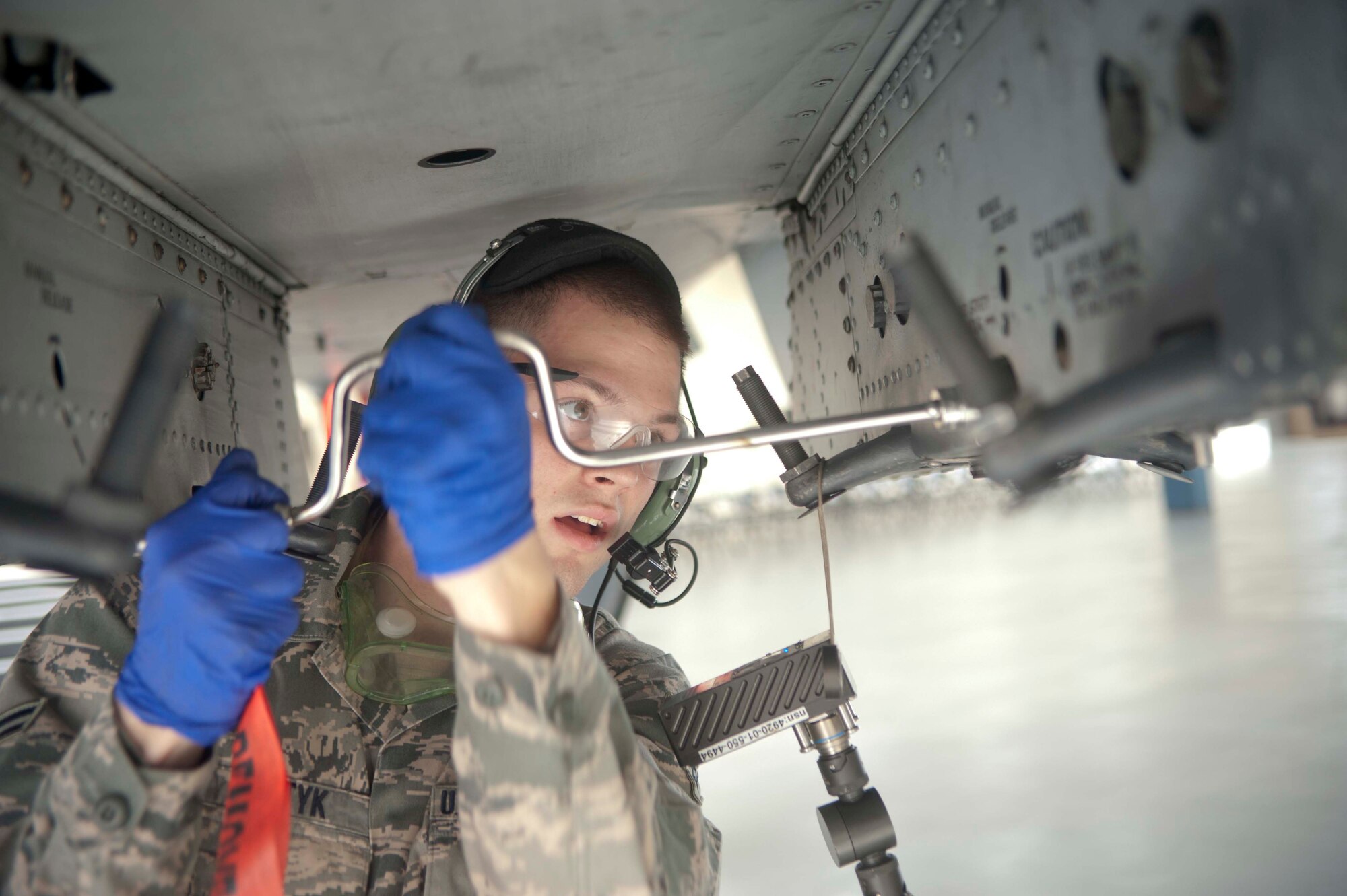 U.S. Air Force Airman 1st Class Trenton Metyk, 75th Aircraft Maintenance Unit load crew two man, secures bolts on an A-10C Thunderbolt II during an A-10 Weapons Load Crew of the Quarter Competition at Moody Air Force Base, Ga., Jan. 11, 2013. Holding the two man position, Metyk tightened bolts, checked over bomb placements and organized tools during the competition. (U.S. Air Force photo by Airman Paul Francis/Released) 
