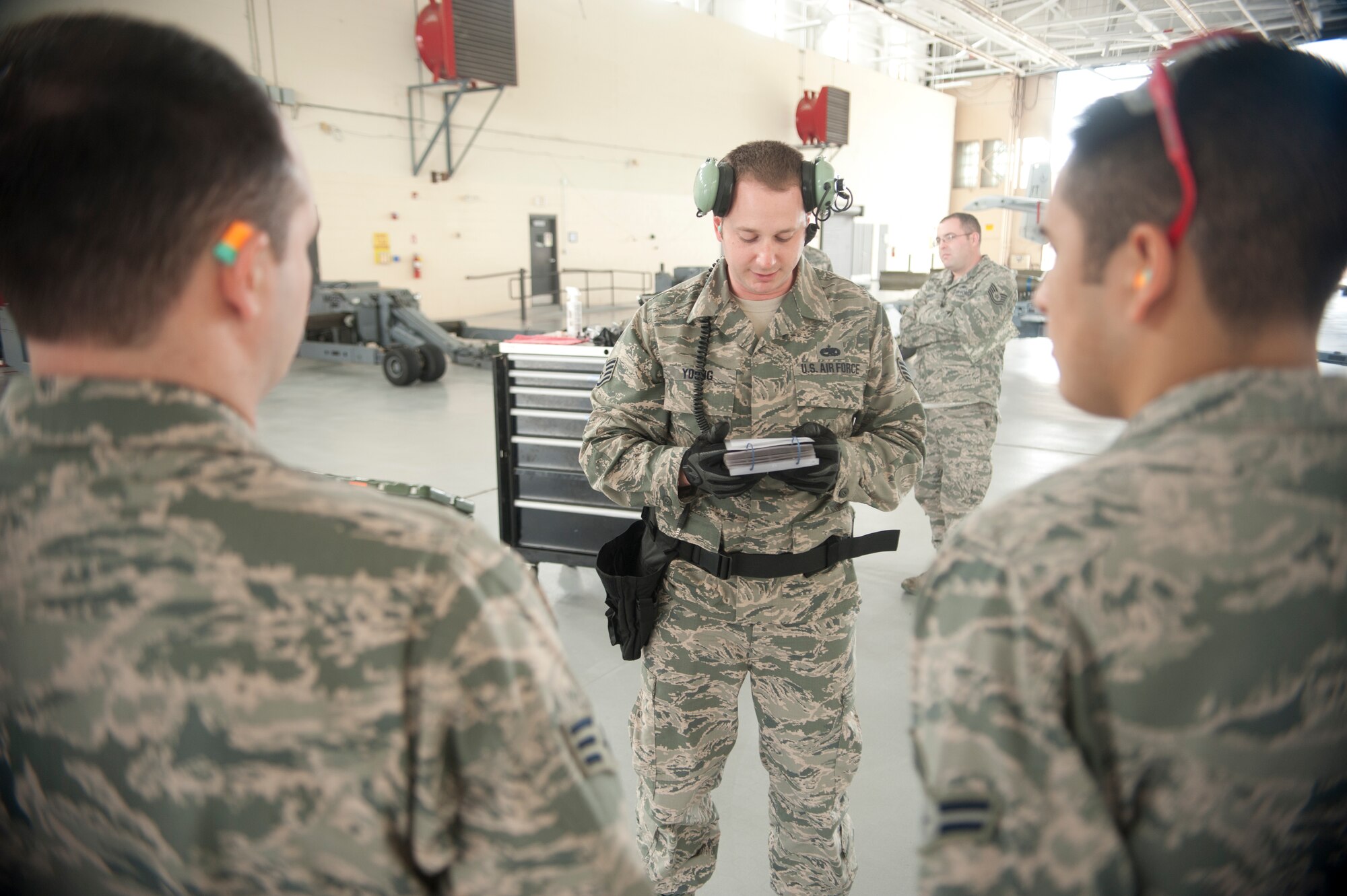 U.S. Air Force Staff Sgt. Joshua Young, 74th Aircraft Maintenance Unit crew chief, breaks down the game plan to his team to prepare for an A-10 Weapons Load Crew of the Quarter Competition at Moody Air Force Base, Ga., Jan 11, 2013. In addition to loading munitions as fast as possible, the team was also judged on safety and following correct procedures. (U.S. Air Force photo by Airman Paul Francis/Released) 
