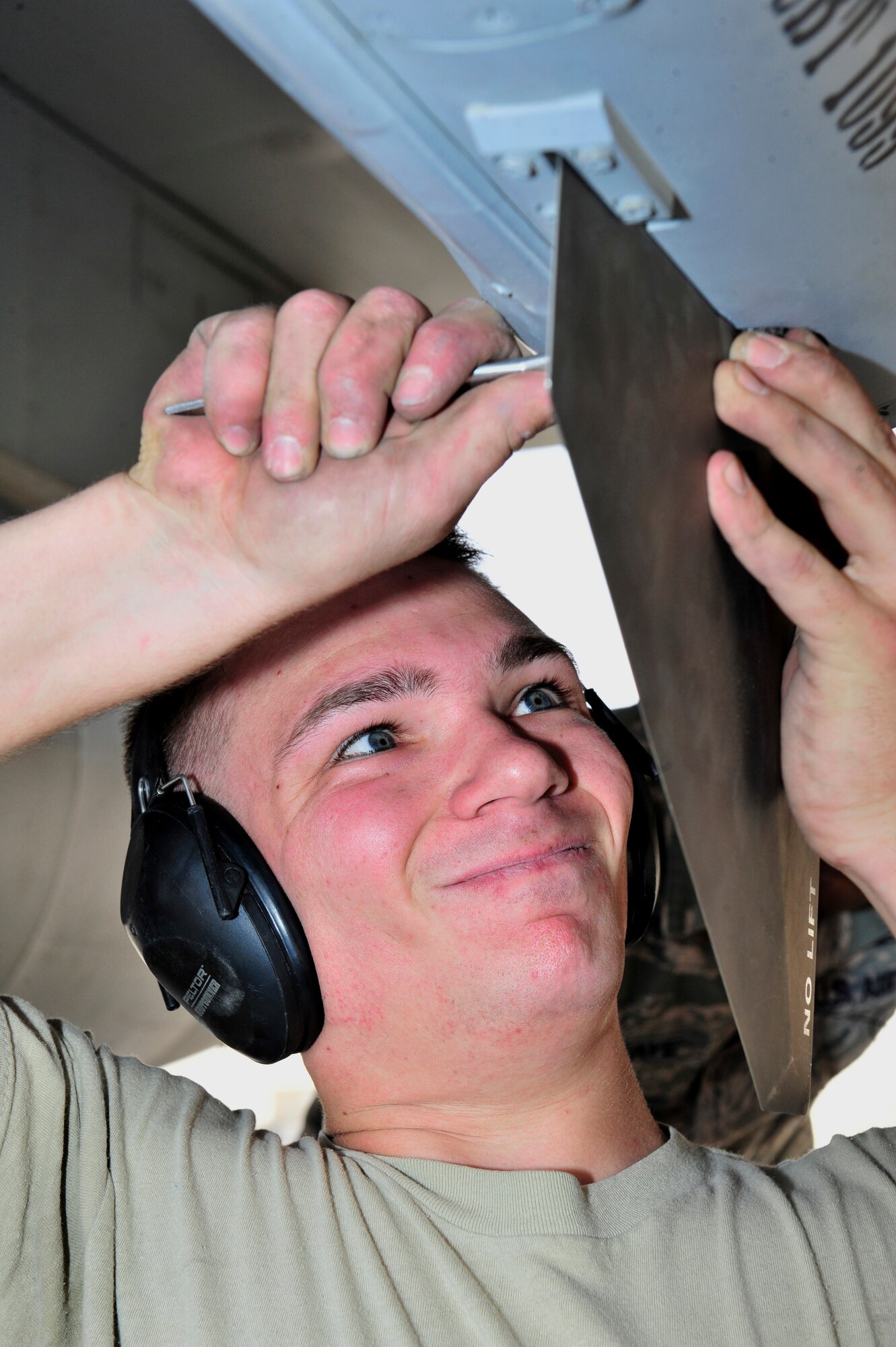 SOUTHWEST ASIA -- U.S. Air Force Airman 1st Class Sean McNelly, 380th Expeditionary Aircraft Maintenance Squadron weapons load crew member, competes in the quarterly Weapons Loading Competition Jan. 13, 2013. The 380th Expeditionary Maintenance Group established the competition to exercise teamwork skills, proficiency and core combat competency in the deployed environment. (U.S. Air Force photo/Tech. Sgt. Christina M. Styer) (RELEASED) 