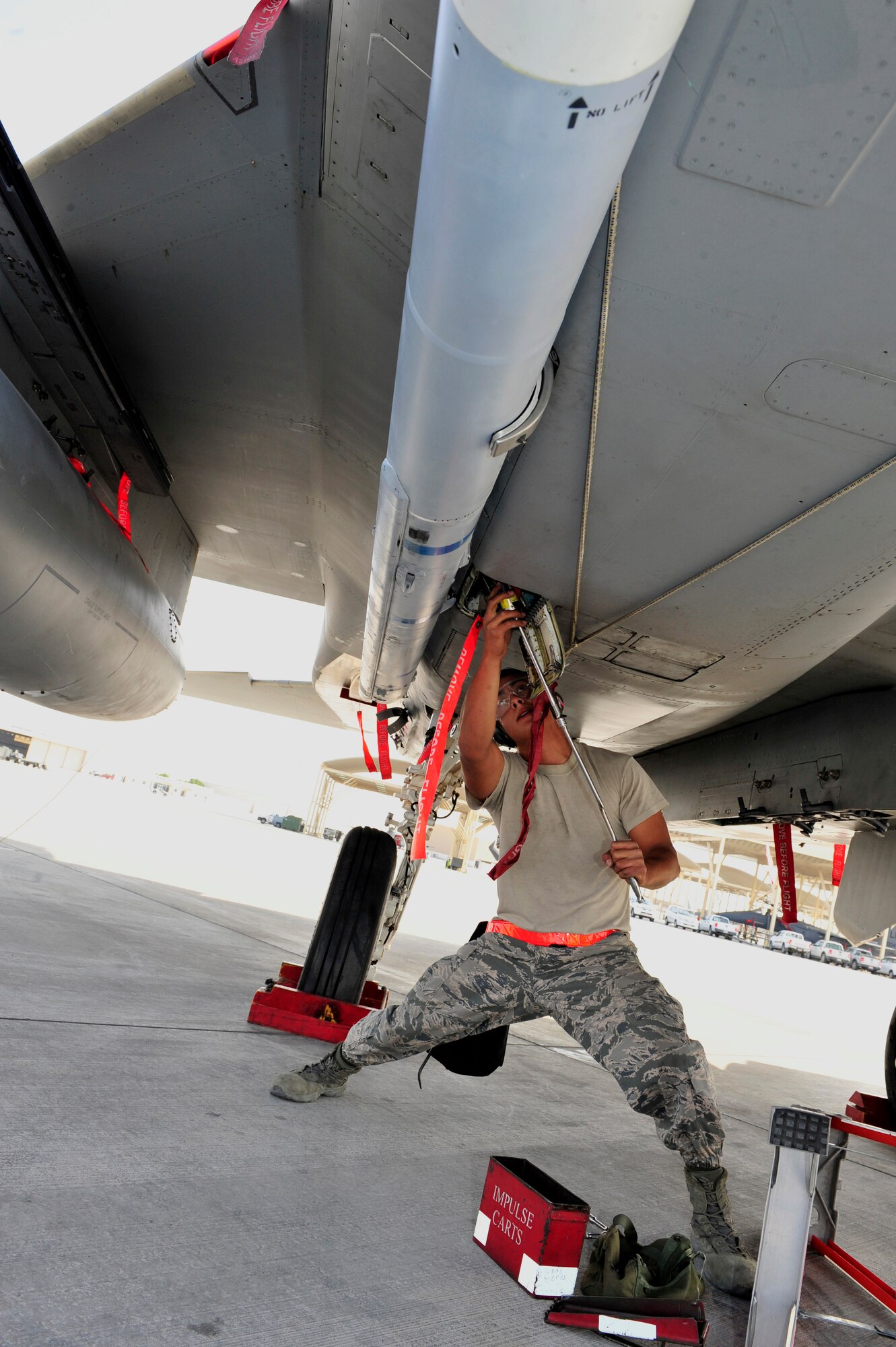 SOUTHWEST ASIA -- U.S. Air Force Senior Airman Nicholas Balagat, 380th Expeditionary Aircraft Maintenance Squadron weapons load crew member, attaches a missile to an F-15 Eagle Jan. 13, 2013. Weapons load crews from multiple airframes demonstrated their teamwork skills and proficiency in the deployed environment during the quarterly Weapons Loading Competition. (U.S. Air Force photo/Tech. Sgt. Christina M. Styer) (RELEASED) 