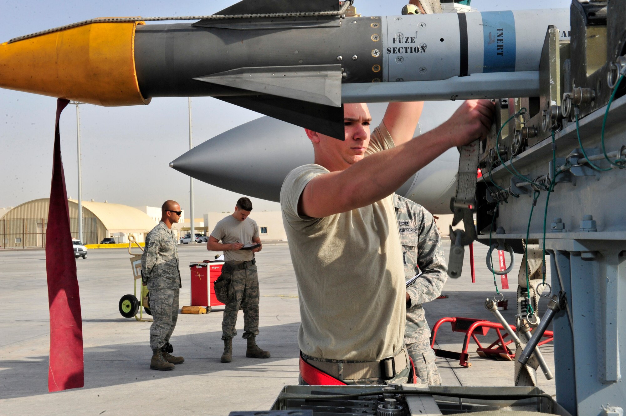 SOUTHWEST ASIA -- U.S. Air Force Airman 1st Class Sean McNelly, 380th Expeditionary Aircraft Maintenance Squadron weapons load crew member, prepares a missile to be loaded during the Weapons Loading Competition Jan. 13, 2013. The competition allowed members of three different airframes to test their teamwork skills and proficiency in the deployed environment. (U.S. Air Force photo/Tech. Sgt. Christina M. Styer) (RELEASED) 