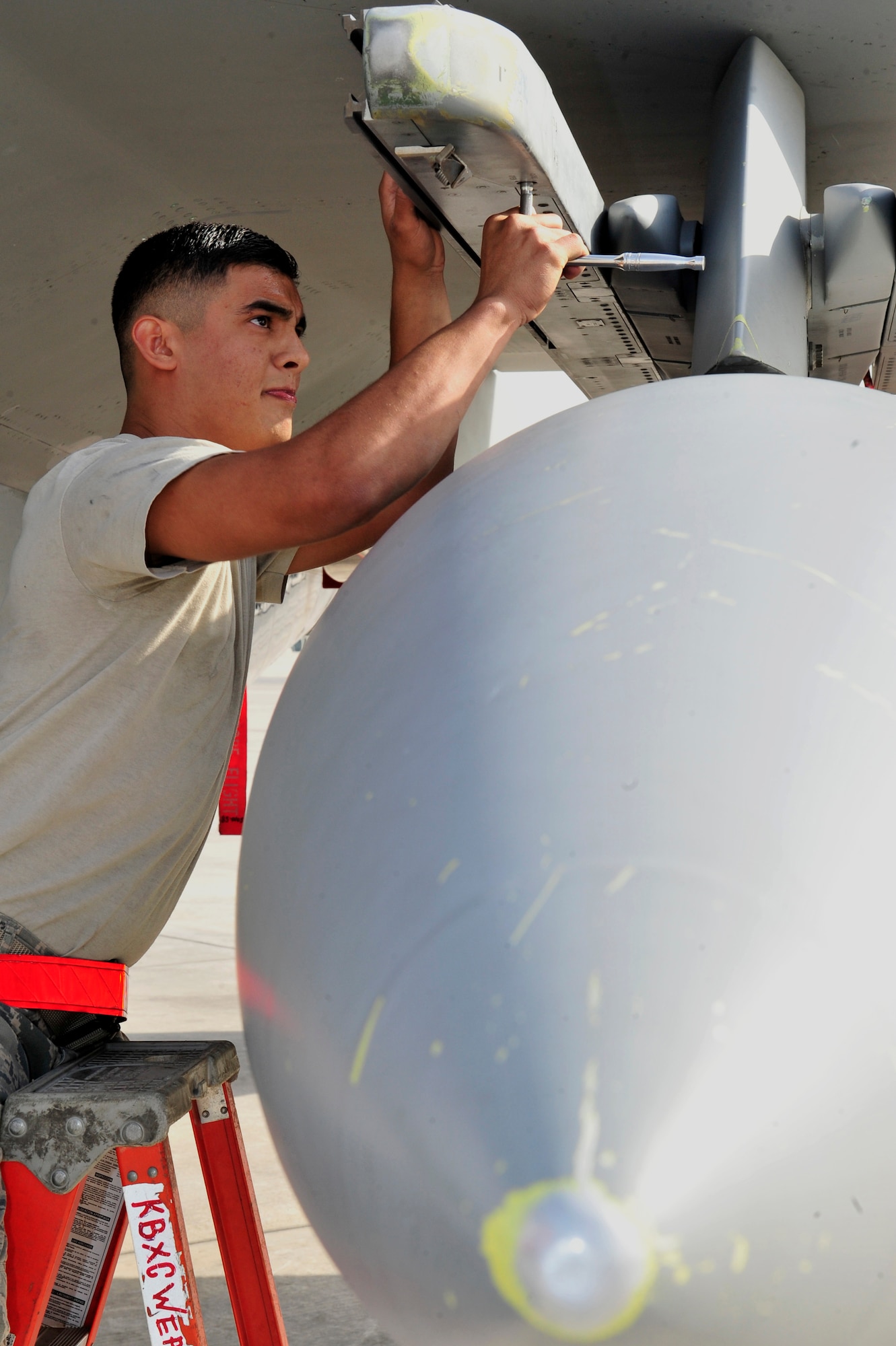 SOUTHWEST ASIA -- U.S. Air Force Senior Airman Nicholas Balagat, 380th Expeditionary Aircraft Maintenance Squadron weapons load crew member, participates in the 380th Air Expeditionary Maintenance Group quarterly Weapons Loading Competition Jan. 13, 2013. Balagat and two teammates are deployed from Kadena Air Base, Japan and competed against other crews from multiple airframes for the "Best Load Crew" title. (U.S. Air Force photo/Tech. Sgt. Christina M. Styer) (RELEASED) 