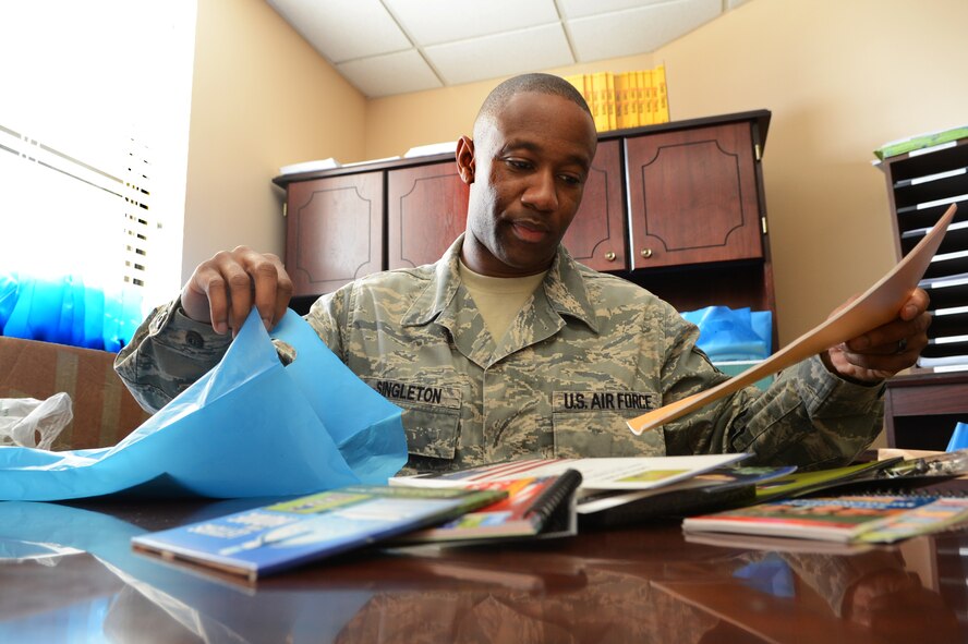 U.S. Air Force Tech. Sgt. Evan Singleton, 20th Force Support Squadron, Airman & Family Readiness Center, non commissioned officer in charge prepares a pre-deployment packet at Shaw Air Force Base, S.C., Jan. 14, 2013.   Singleton is the Shaw Spotlight for the week of Jan. 9 - 14. (U.S. Air Force photo by Airman 1st Class Nicole Sikorski/Released)
