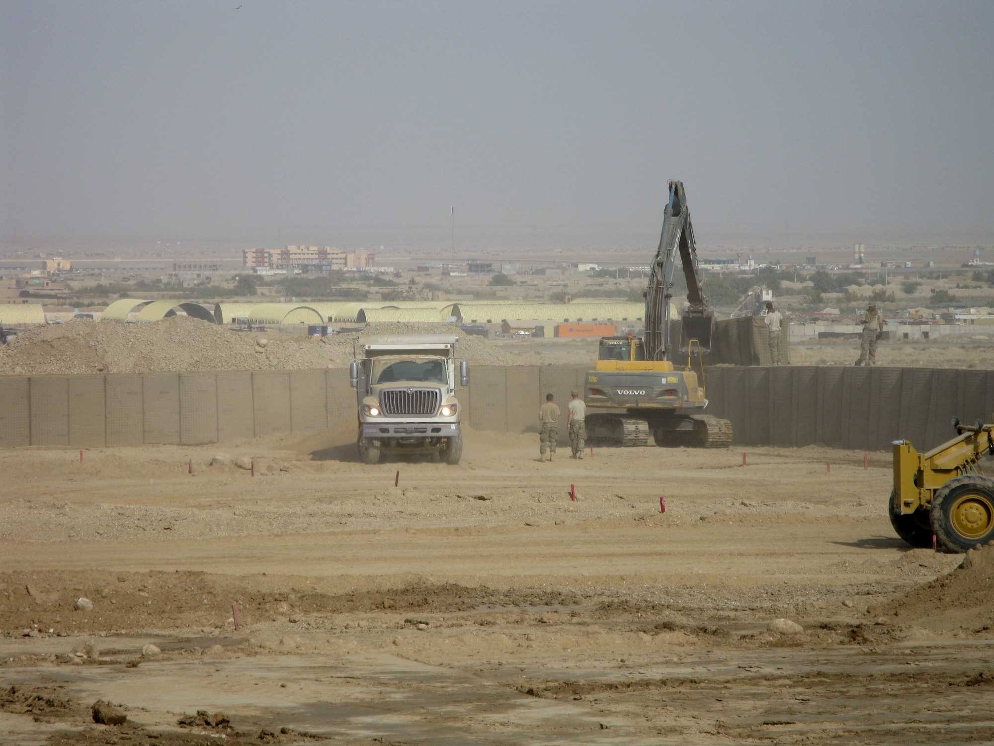 CAMP JOHN PRATT, Afghanistan – Airmen from the 554th RED HORSE Squadron use heavy machinery to fill up Hesco barriers with dirt to create the inner structure of a safety berm to surround and protect a fuel reservoir at Camp John Pratt, Afghanistan, in October 2012. The 554 RHS is currently deployed downrange in support of U.S. Central Command’s Operation Enduring Freedom. (Courtesy photo)