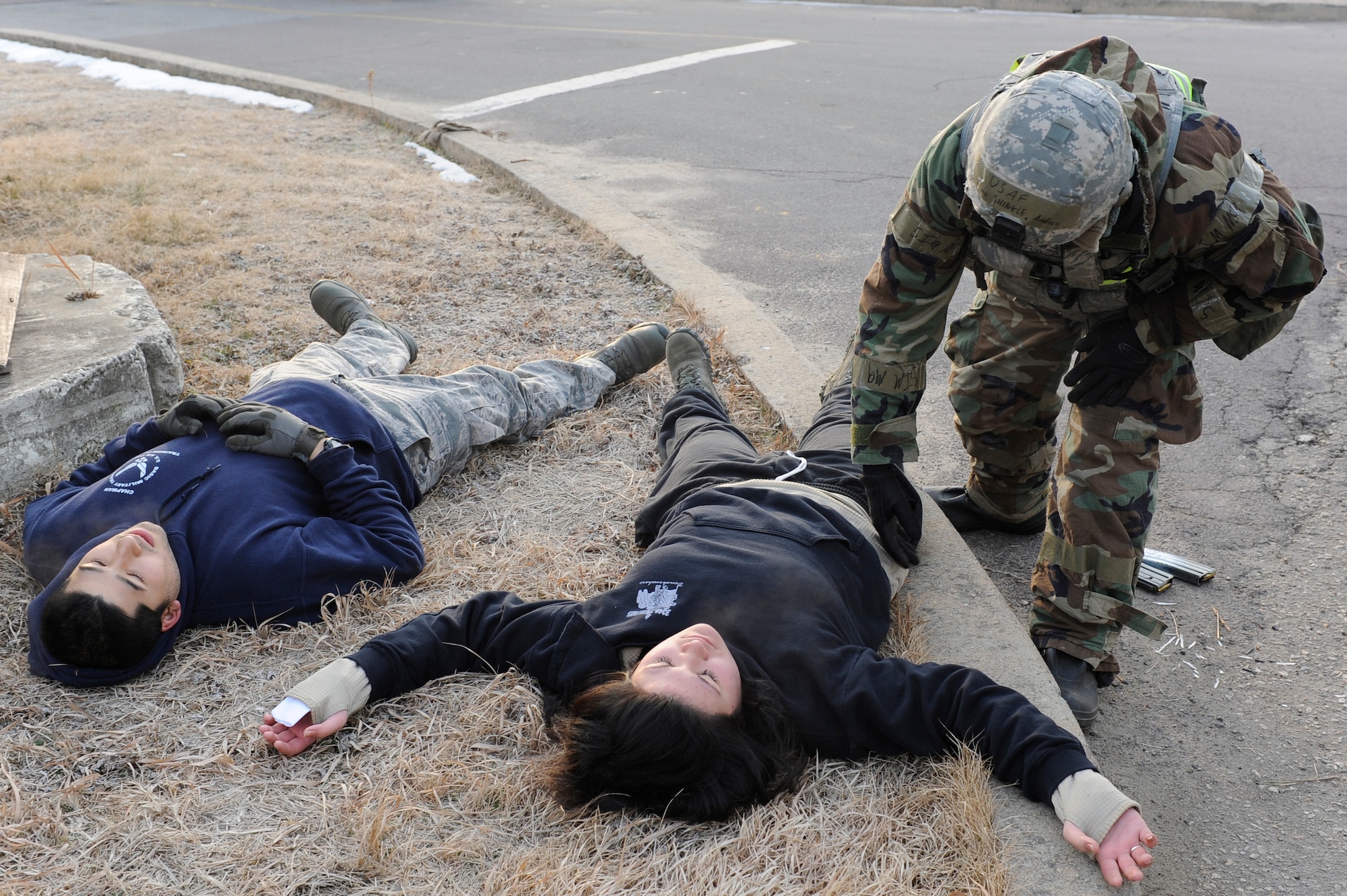 Airman Andrew Shinkle, 8th Security Forces Squadron, searches the simulated casualties of the opposing force during Exercise Beverly Midnight 13-1 at Kunsan Air Base, Republic of Korea, Jan 15, 2013. Shinkle checked the bodies for explosives and retrieved their ammunition. (U.S. Air Force photo by Senior Airman Marcus Morris/released)