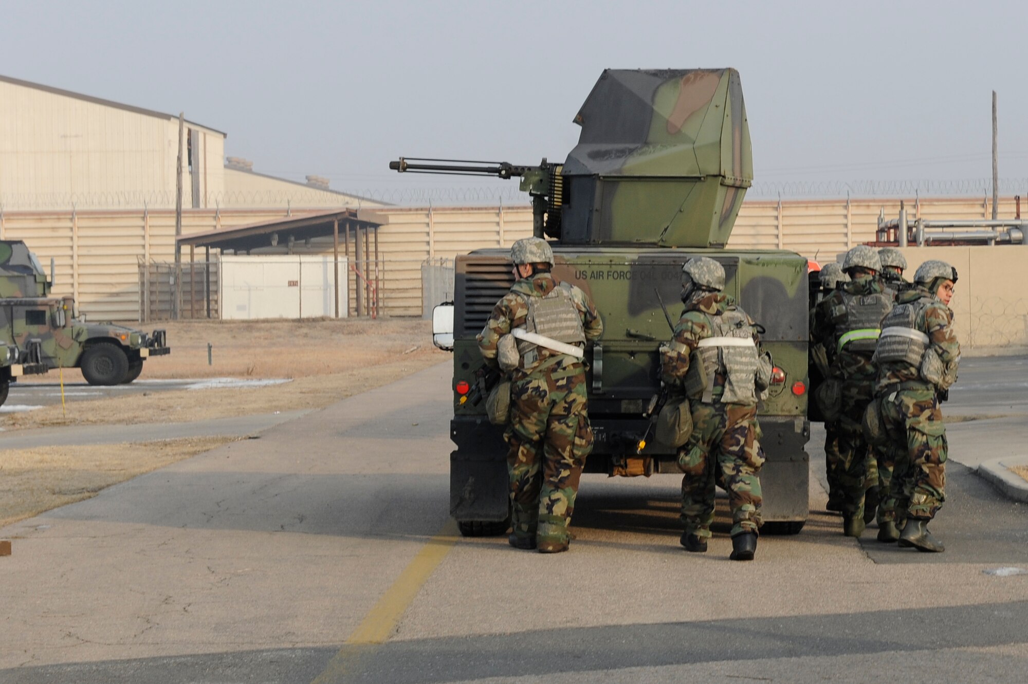 Members of 8th Security Forces Squadron use a Humvee as cover during Exercise Beverly Midnight 13-1 at Kunsan Air Base, Republic of Korea, Jan 15, 2013. The Airmen tactically eliminated the remaining opposing forces and prevented Radar Approach Control from being taken over. (U.S. Air Force photo by Senior Airman Marcus Morris/released)
