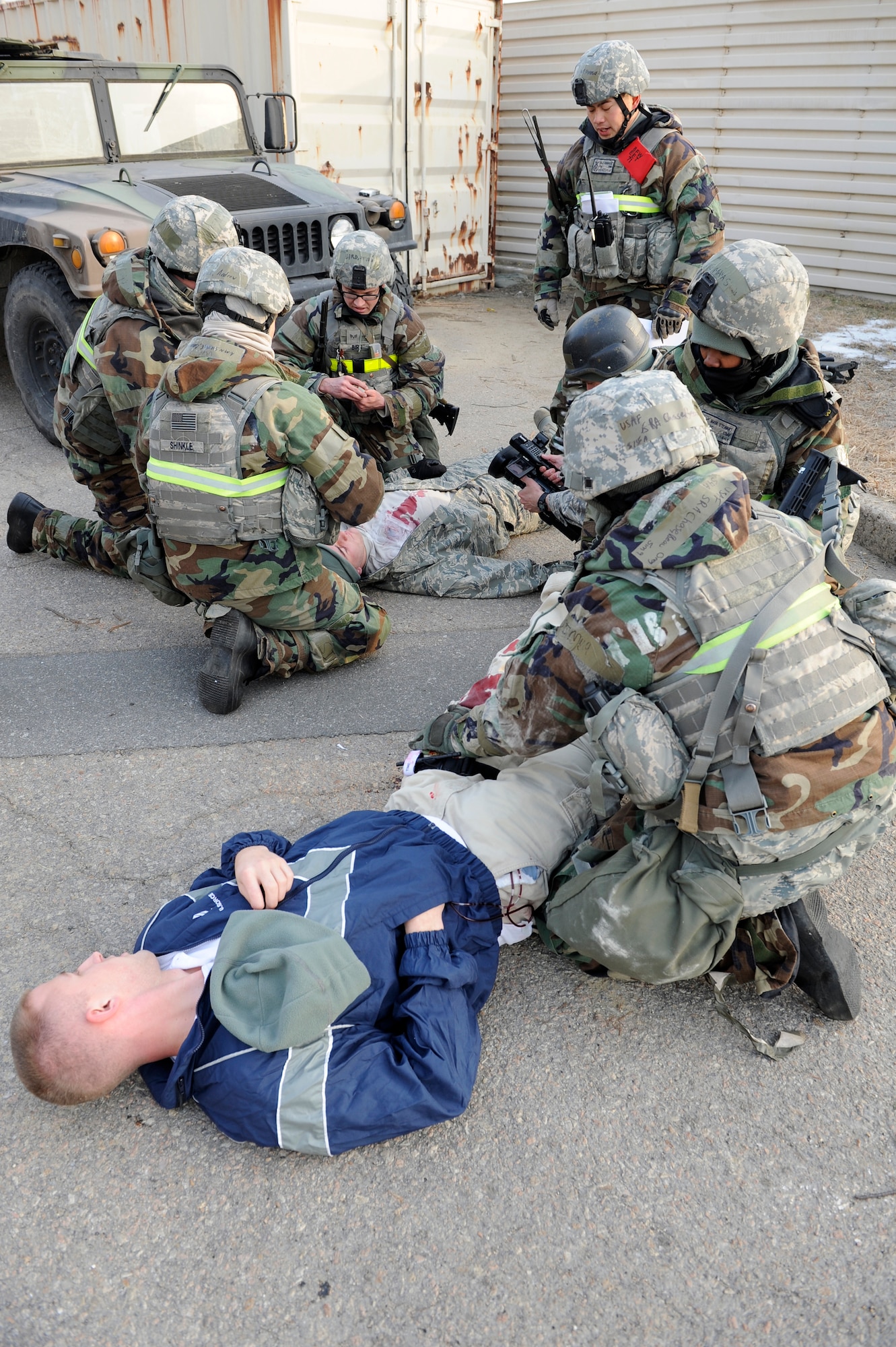 Members of 8th Security Forces Squadron treat teammates who were simulated shot in an opposing forces attack during Exercise Beverly Midnight 13-1 at Kunsan Air Base, Republic of Korea, Jan 15, 2013. The Airmen quickly stopped the bleeding by using combat Self-Aid and Buddy Care. (U.S. Air Force photo by Senior Airman Marcus Morris/released)