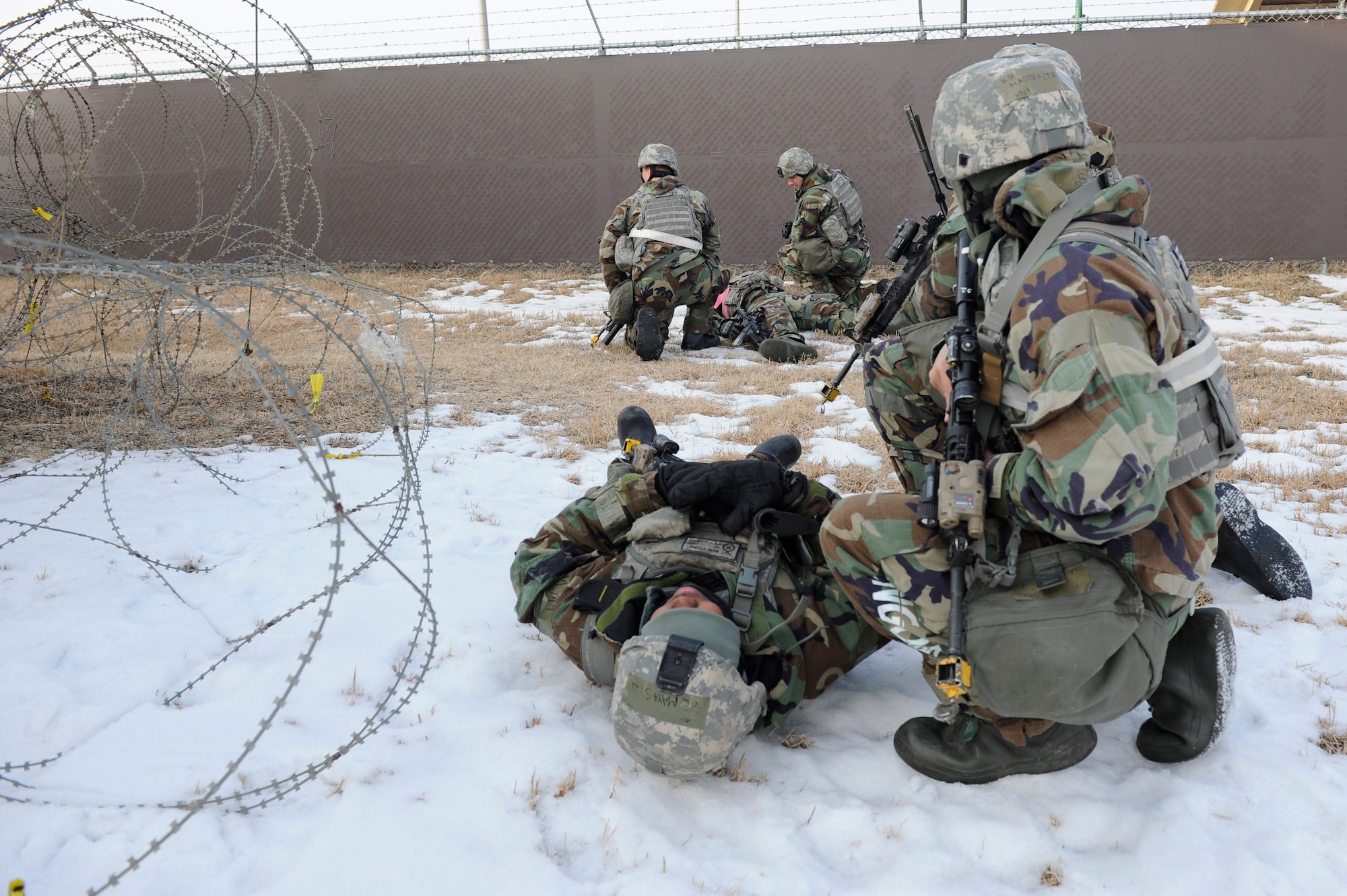 Staff Sgt. Travis Martho, 8th Security Forces Squadron, evaluates the condition of a wounded teammate during Exercise Beverly Midnight 13-1 at Kunsan Air Base, Republic of Korea, Jan 15, 2013. Martho quickly called for back-up and assisted his team with taking out the remaining opposing forces. (U.S. Air Force photo by Senior Airman Marcus Morris/released)