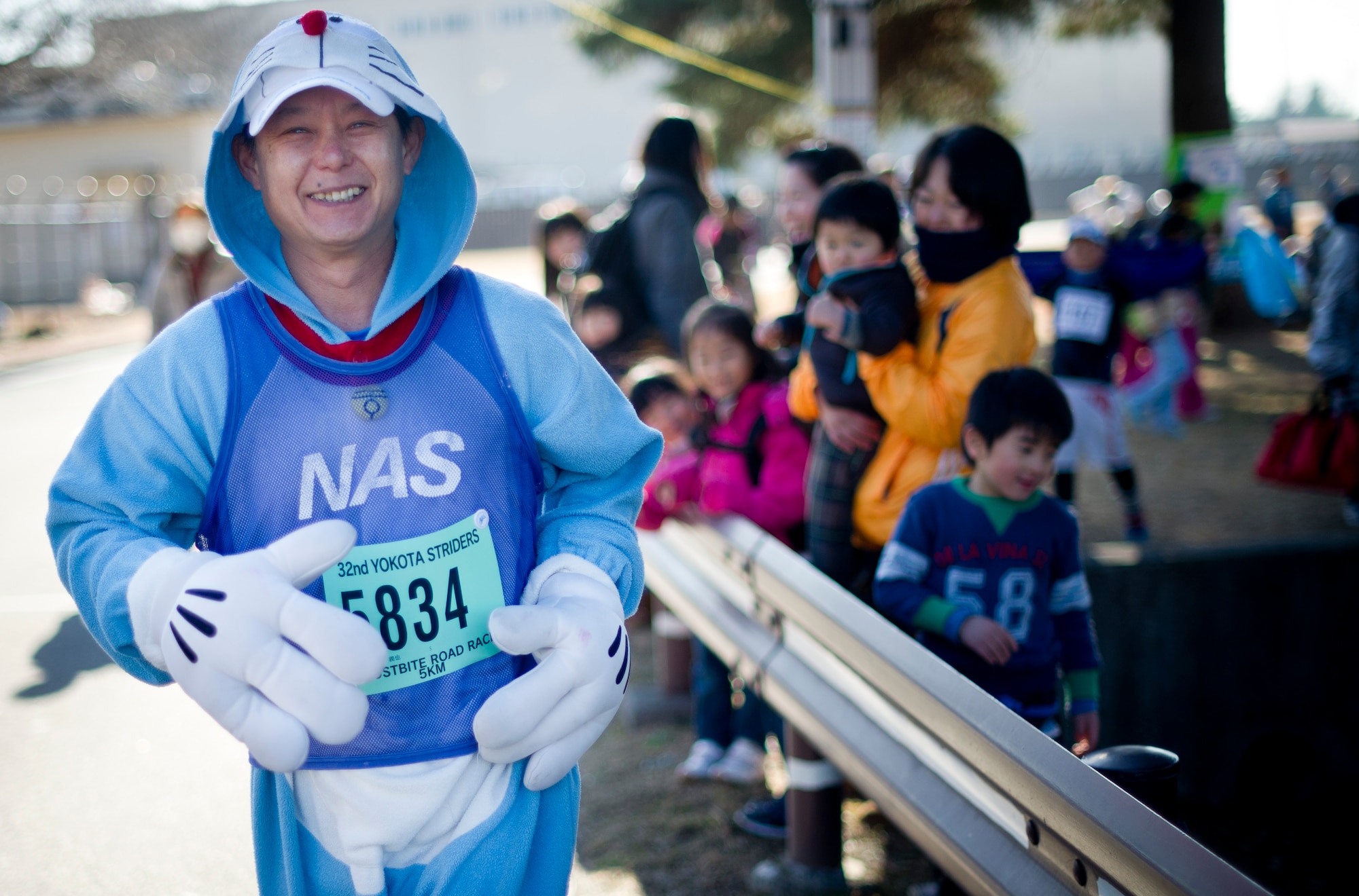YOKOTA AIR BASE, Japan -- A costumed Japanese runner begins the 5k race during the annual Frostbite Run Jan. 13, 2013, at Yokota Air Base, Japan. Many of the runners chose to wear funny or creative costumes. This year, more than 10, Japanese runners came through the gates of Yokota for the race. (U.S. Air Force photo by Staff Sgt. Stacy Moless)