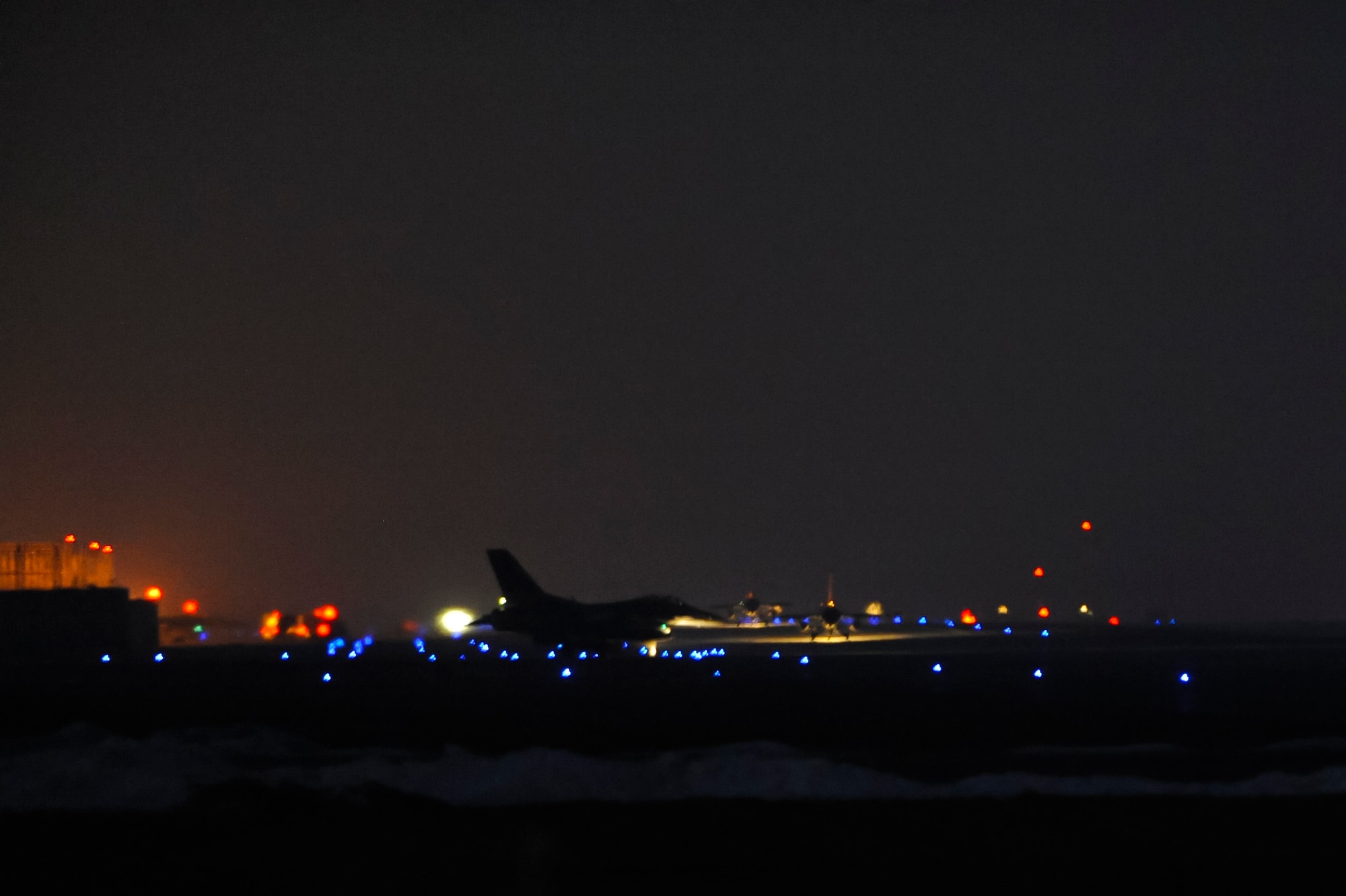 F-16 Fighting Falcons move down the runway for the first take off during Exercise Beverly Midnight 13-1 at Kunsan Air Base, Republic of Korea, Jan 15, 2013. The exercise was the first of the new year and demonstrated the Wolf Pack’s capabilities of taking the fight north. (U.S. Air Force photo by Senior Airman Marcus Morris/released)