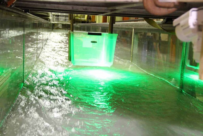 National Science Foundation-sponsored New York University researchers penetrate ERDC’s Ice Engineering flume with green laser light as they attempt to develop a better understanding of the interaction between turbulence and the laminar ice boundary layer at the Hanover laboratory.