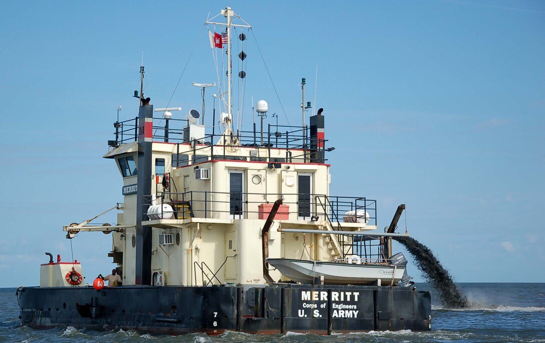 The sidecast, shallowdraft dredge MERRITT clears shoals from the federal channel at Rodanthe after Hurricane Irene hit coastal North Carolina in late August of 2011.  (USACE photo by Hank Heusinkveld)  