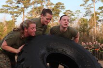 Three Marines from Combat Logistics Regiment 27, 2nd Marine Logistics Group flip a tire during a physical training session aboard Camp Lejeune, N.C., Jan. 11, 2013. This team of Marines battled against other three-man-teams to prove they were the strongest at this event and earning them a day off work.