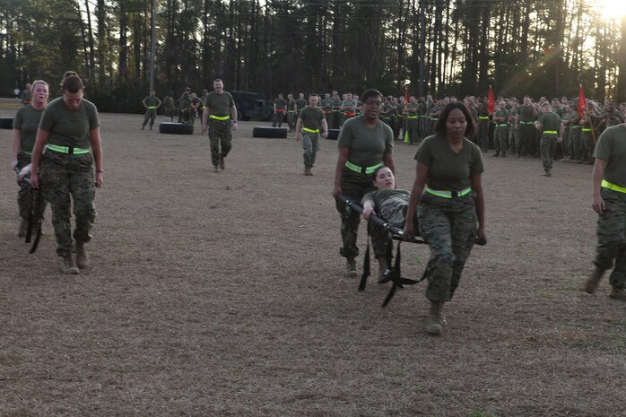 Marines from Combat Logistics Regiment 27, 2nd Marine Logistics Group carry one teammate on a stretcher during a physical training session aboard Camp Lejeune, N.C., Jan. 11, 2013. This team of Marines battled against other three-man-teams to prove they were the strongest at the event and earning them a day off work.