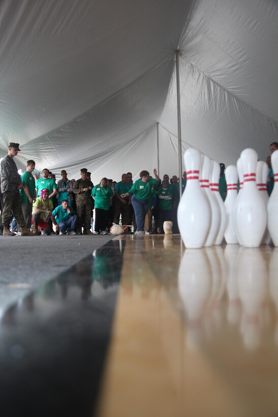 Melissa Stanford, a Special Olympics athlete, bowls for a strike during Cherry Point Commissary’s 6th Annual Special Olympics held outside of the Commissary, Jan. 8.  Stanford and the other athletes competed in several events attempting to win prizes that ranged from Marine Corps T-shirts to Nintendo Wiis.