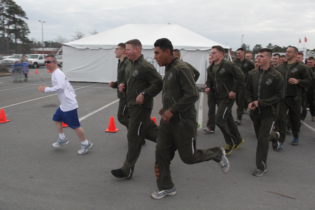 Andy Delafield, a Special Olympian, leads a group of Marines on a 5K run aboard the air station during the Cherry Point 6th Annual Special Olympics event at the air station commissary Jan. 8.   