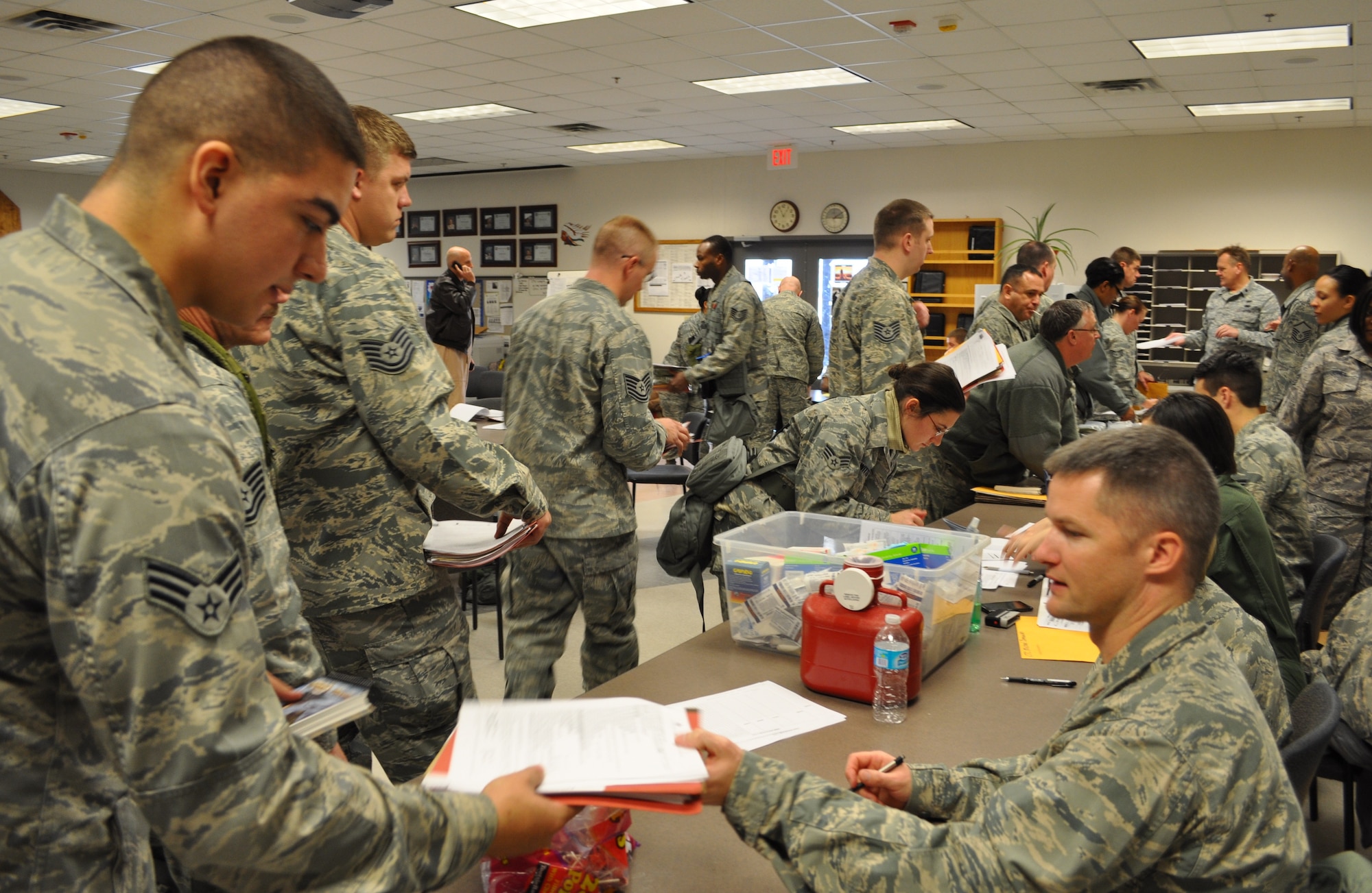 Maj. Ben Berzinis, 507th Medical Squadron, reviews mobility folders as reservists file through the deployment line here Jan. 5. Over 130 reserve Airmen deployed to Southwest Asia in support of Air Refueling Operations in the U.S. Central Command area of responsibility early this month. (U.S. Air Force photo by Capt. Jon Quinlan)