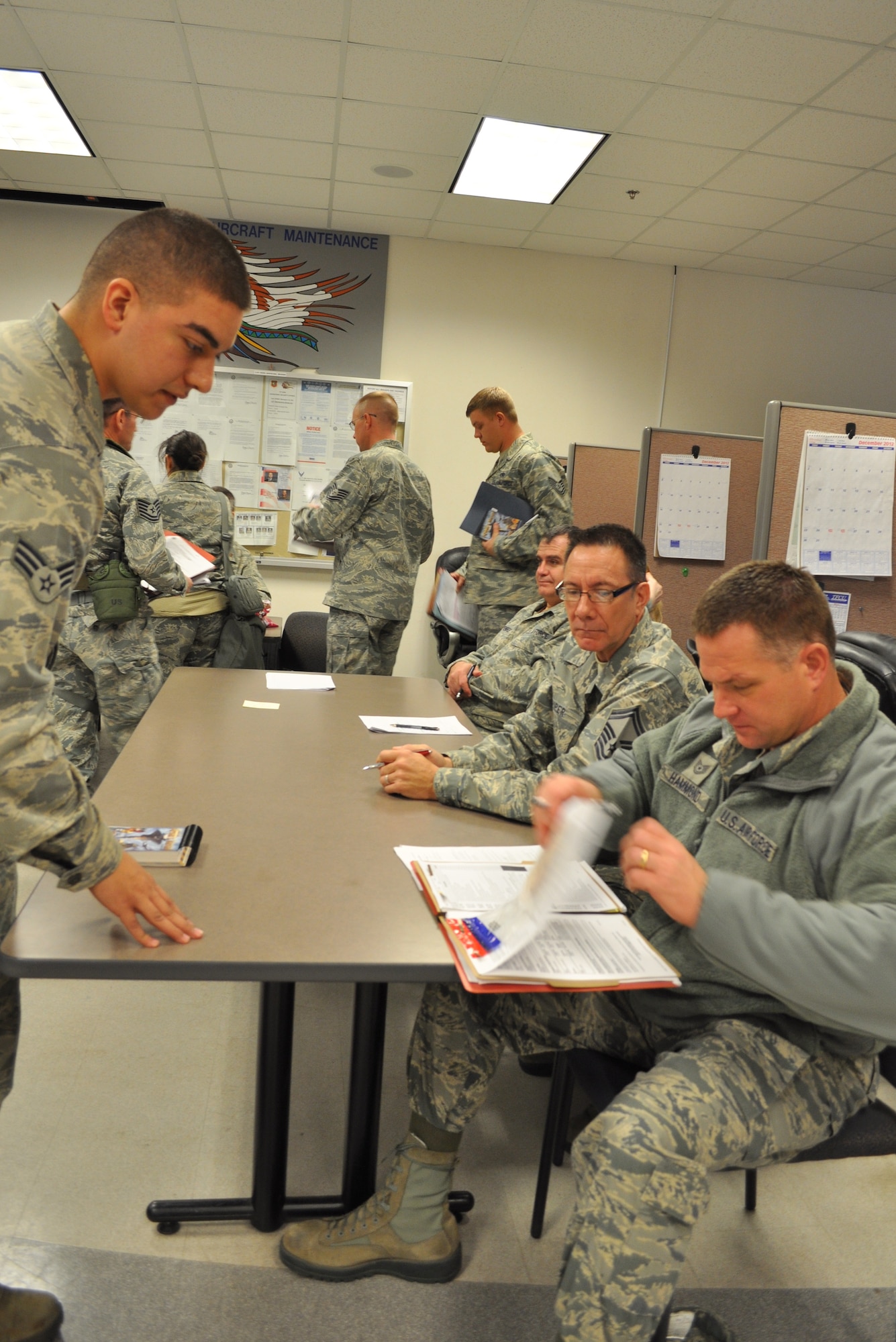 Tech Sgt. Bruce Hammond, 507th Force Support Squadron processes the deployment mobility folder of Senior Airman Kristopher Waterhouse, here Jan. 5.  Over 130 reserve Airmen deployed to Southwest Asia in support of Air Refueling Operations in the U.S. Central Command area of responsibility early this month. (U.S. Air Force photo by Capt. Jon Quinlan)