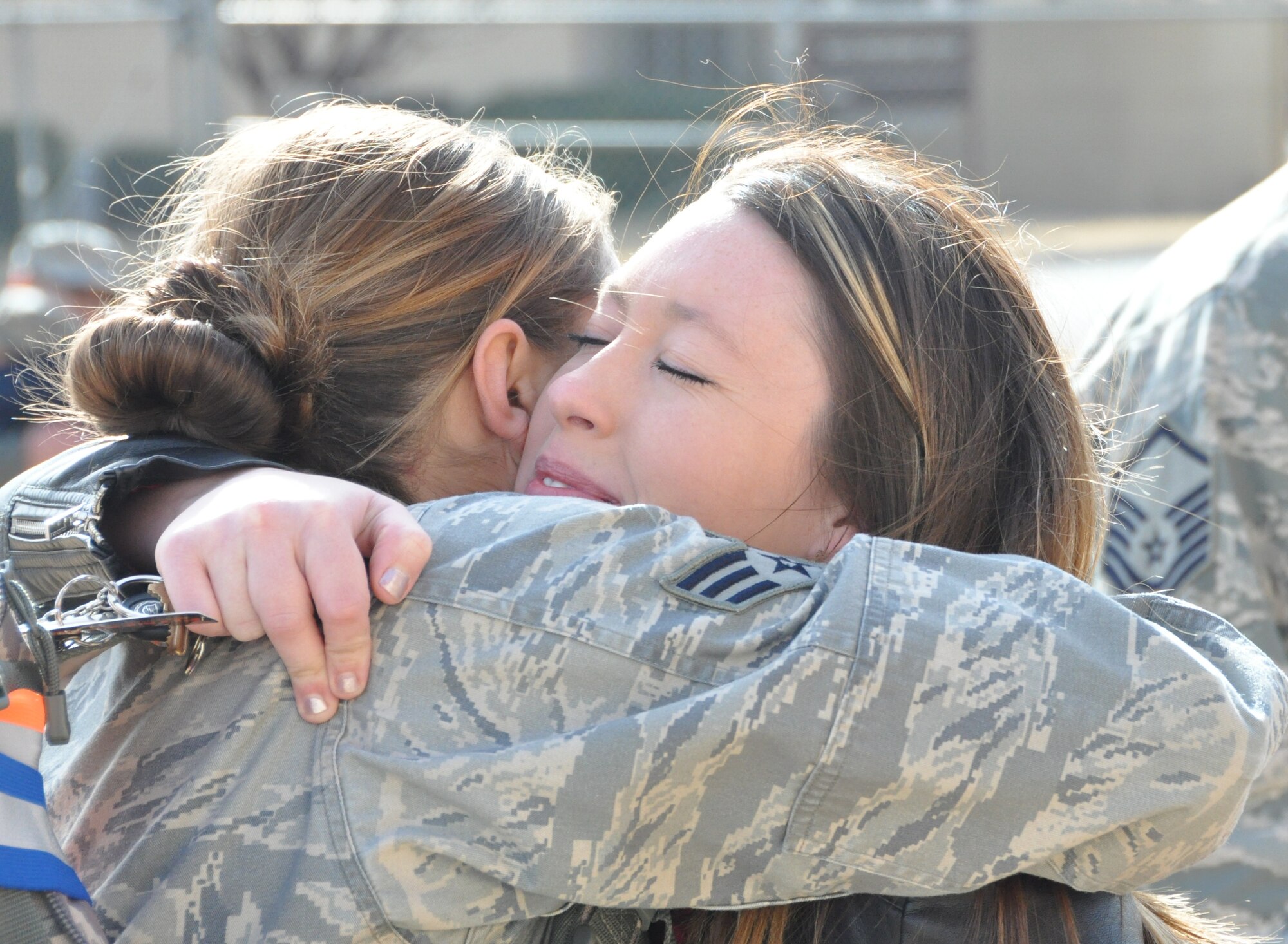 Whitney Dunning (right), wife of Senior Airman Michael Dunning, 507th Aircraft Maintenance Squadron, hugs her friend Senior Airman Holly Way, 507th AMXS.  They all deployed to the U.S. Central Command area of responsibility early this month. (U.S. Air Force photo by Senior Airman Mark Hybers)