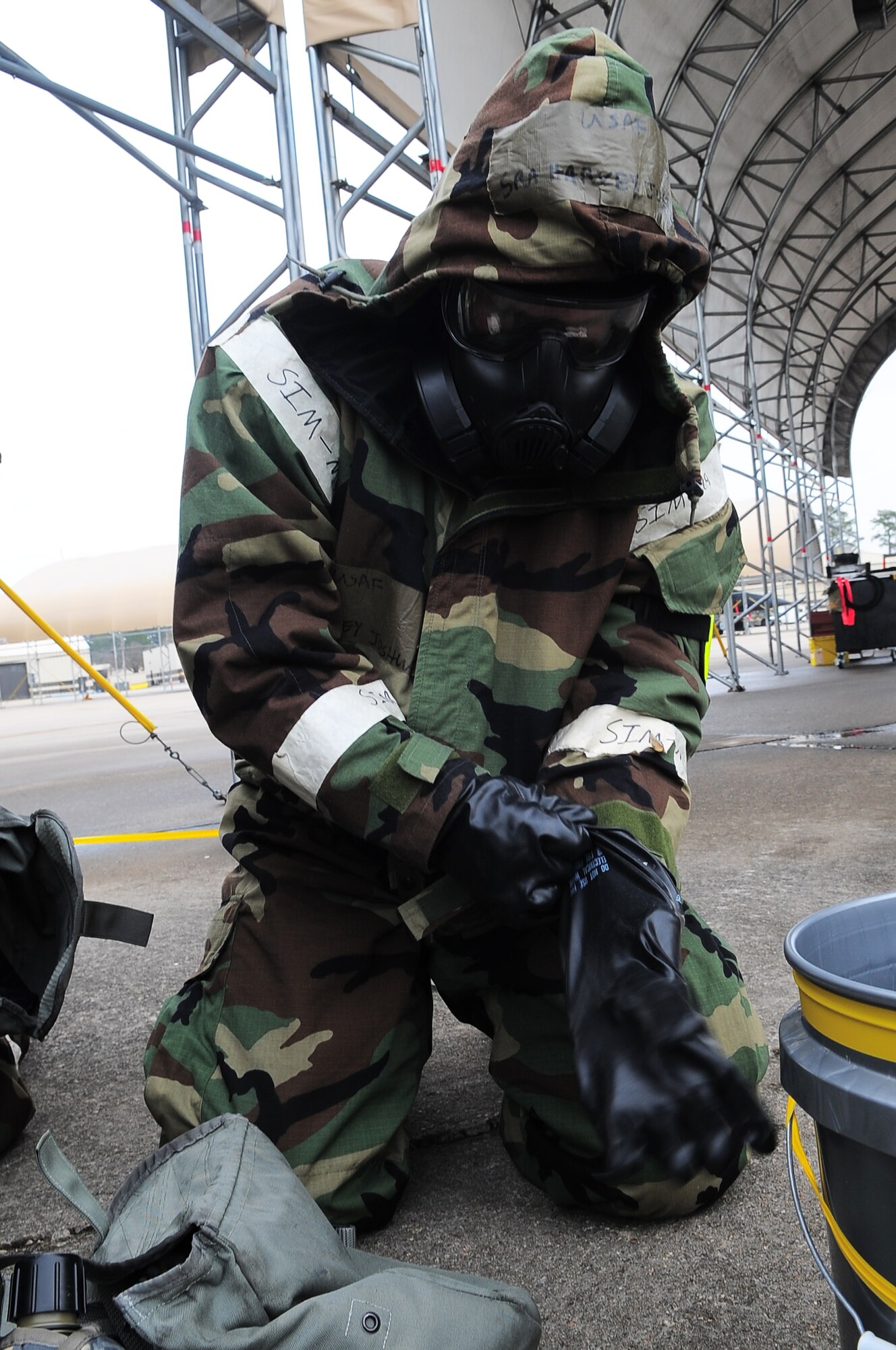 U.S. Air Force Senior Airman Joshua Harvey, 4th Aircraft Maintenance Squadron electronics technician, dons individual protective equipment during Operational Readiness Exercise Coronet Warrior 13-01, at a simulated, deployed location on Seymour Johnson Air Force Base, N.C., Jan 16, 2013. According to the Airman’s Manual, IPE is the minimum personal clothing and equipment needed to protect Airmen from chemical, biological, radiological and nuclear hazards. (U.S. Air Force photo/Airman 1st Class Aubrey White/Released)