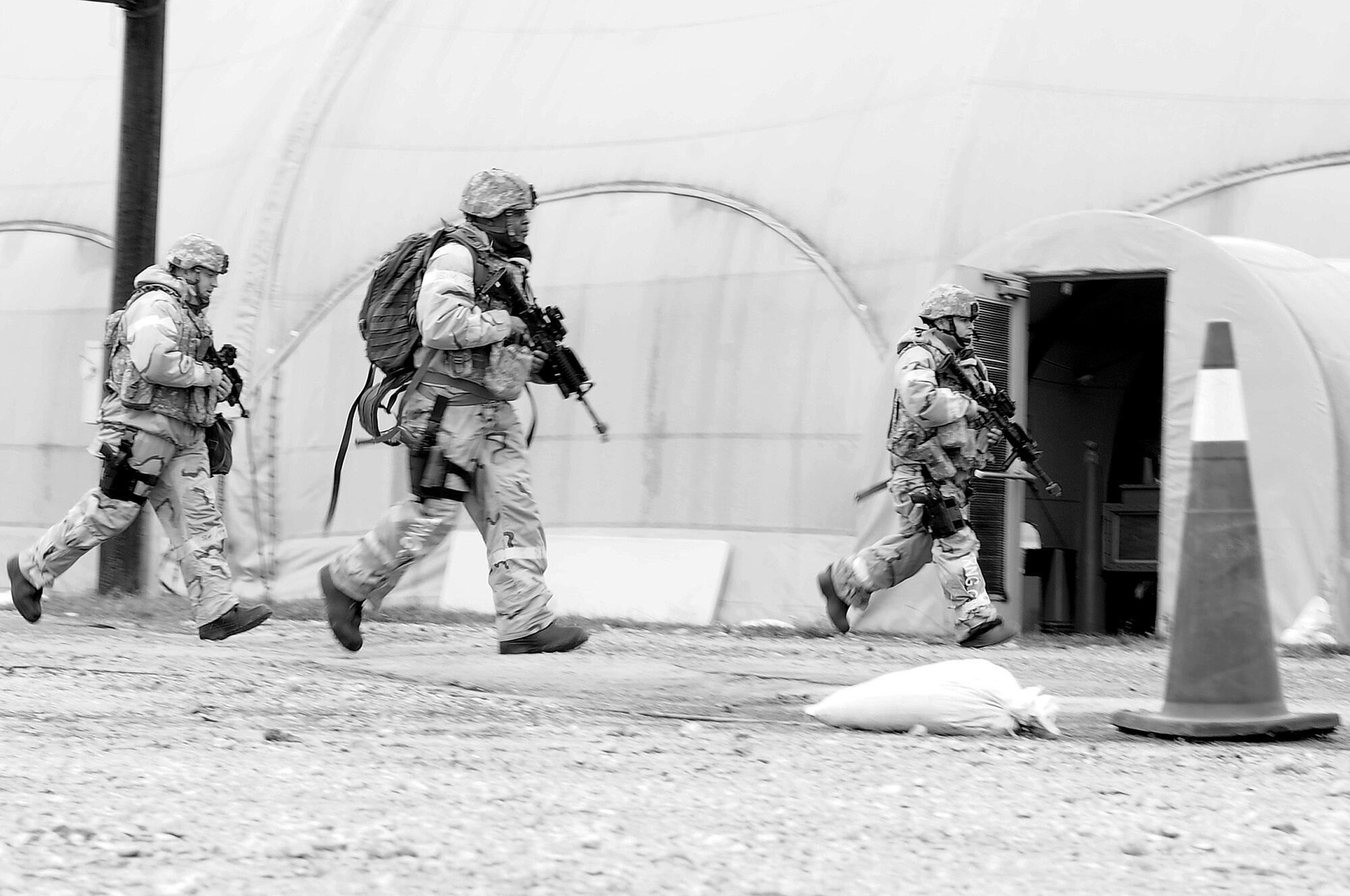 U.S. Air Force Airmen assigned to the 4th Security Forces Squadron seek cover during Operational Readiness Exercise Coronet Warrior 13-01, at a simulated, deployed location on Seymour Johnson Air Force Base, N.C., Jan. 16, 2013. Airmen were tested on their reactions to various simulated conflicts to ensure mission readiness. (U.S. Air Force photo/Airman 1st Class Aubrey White/Released)