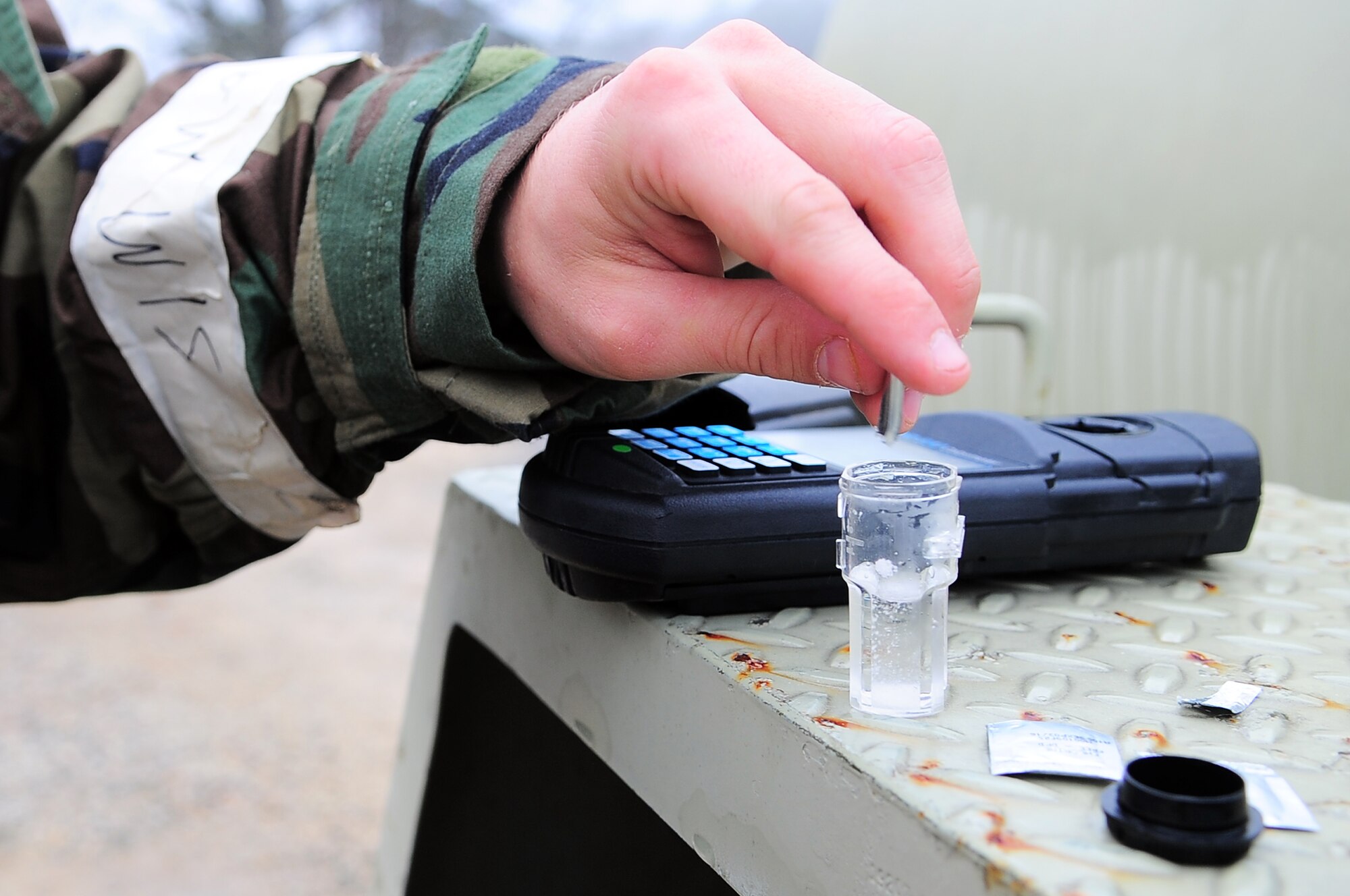 A U.S. Air Force Airman assigned to the 4th Fighter Wing tests a water sample for chlorine residue during Operational Readiness Exercise Coronet Warrior 13-01, at a simulated, deployed location on Seymour Johnson Air Force Base, N.C., Jan 16, 2013. Chlorine and pH levels of the base water supply are checked periodically throughout the day to ensure it is safe for consumption. (U.S. Air Force photo/Airman 1st Class Aubrey White/Released)