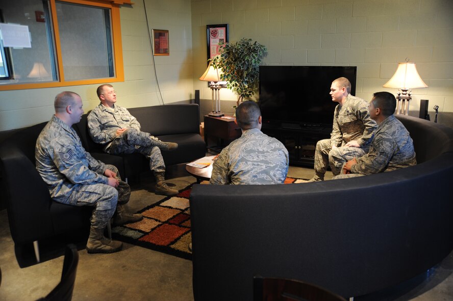 Col. John Kubinec, 377th Air Base Wing commander, sits with members of the 22nd Air Refueling Wing chapel as they explain how The Den in building 350 helps keep dorm Airmen motivated Jan. 8, 2013, McConnell Air Force Base, Kan. The Den is the number one airmen ministry center in AMC. Kubinec was visiting several locations on the base as one of four inspectors during the 2013 Installation Excellence Award inspection. (U.S. Air Force photo/Airman 1st Class Jose L. Leon)