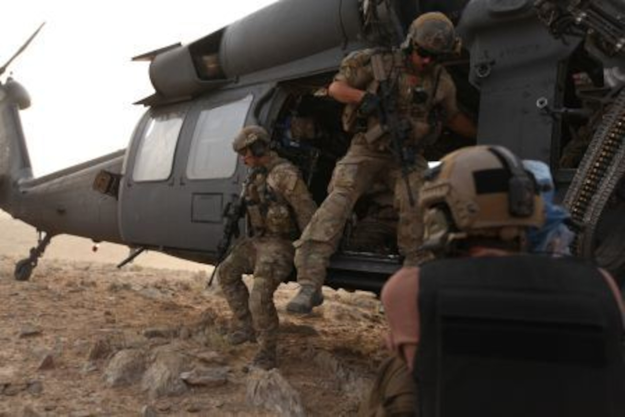 David Clawson, a member of the National Geographic film crew, captures the action for “Inside Combat Rescue” as pararescuemen from Moody Air Force Base, Ga., exit their helicopter after touching down in in a remote area of Afghanistan. The show is a Department of Defense supported Nat Geo television series about Air Force combat rescue efforts in Afghanistan. (National Geographic Channel photo by Jared McGilliard)