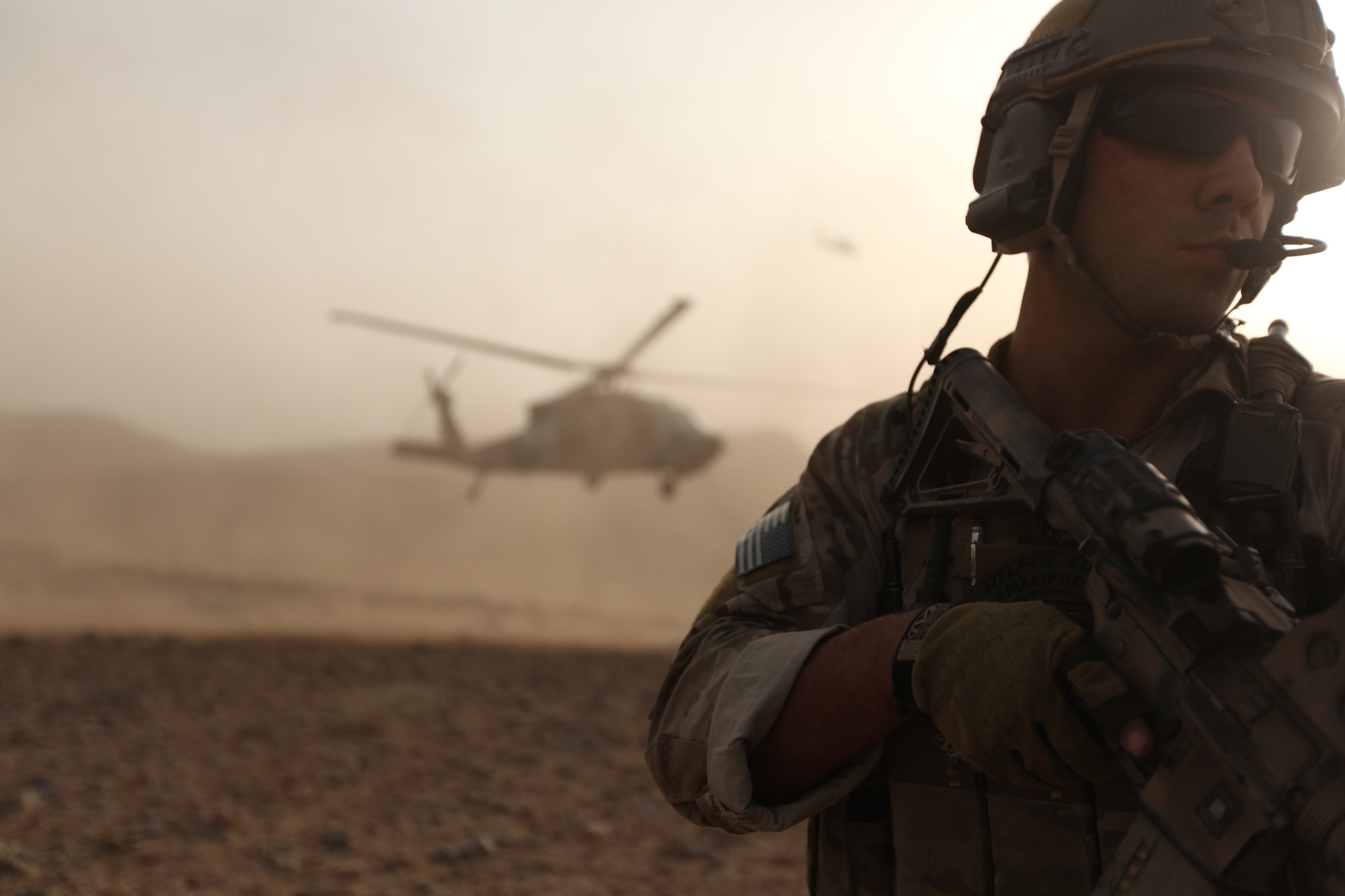 A Moody Air Force Base, Ga., pararescueman, keeps an eye out for any signs of danger while an HH-60 Pave Hawk lifts off in Afghanistan.  In a first-of-its-kind project, Nat Geo had unprecedented access to all aspects of the Air Force rescue mission in Afghanistan for a new television series called "Inside Combat Rescue." (National Geographic Channel photo by Jared McGilliard)