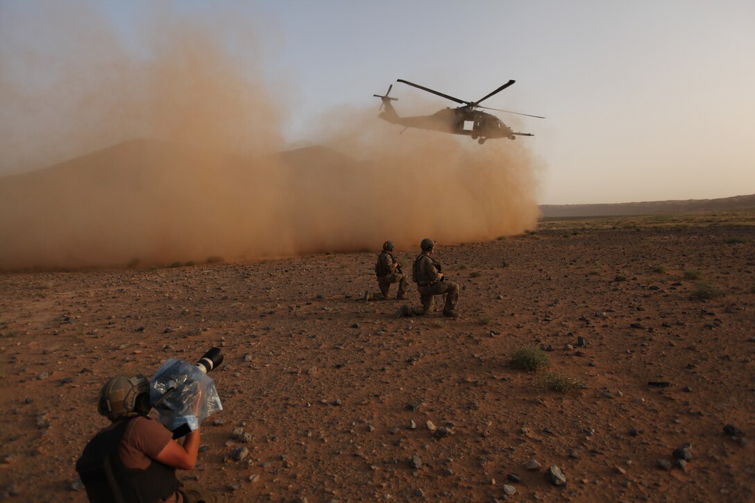 David Clawson, a member of the National Geographic film crew, captures the action as pararescuemen from Moody Air Force Base, Ga., secure the area while an HH-60 Pave Hawk lifts off.  A five-person Nat Geo television crew filmed “Inside Combat Rescue” for five weeks with Airmen from Moody AFB and Pave Hawk crews from Nellis AFB, Nev., at Kandahar Airbase, Afghanistan. (National Geographic Channel photo by John Collin)