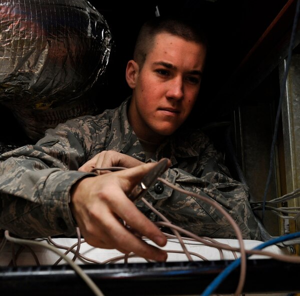 Airman 1st Class Alex Sprague, 2nd Communications Squadron cable and antenna systems, pulls wiring in preparation for removal on Barksdale Air Force Base, La., Jan. 16. Airmen in this section repair and replace wiring and cables across the base and maintain the base's antennas, which are vital to communication. (U.S. Air Force photo/Airman 1st Class Andrew Moua)