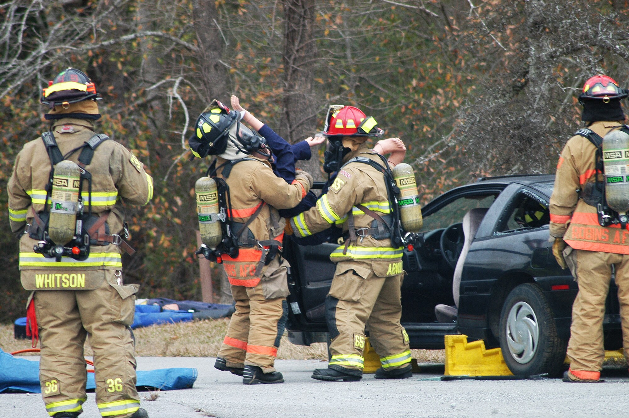A simulated victim is removed from a vehicle during a fire training exercise. (U. S. Air Force photo/Sue Sapp)