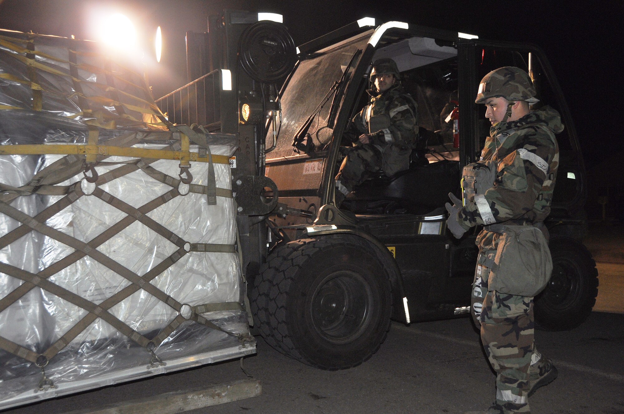 Staff Sgt. Juan Torres de la Cruz, 51st Logistics Readiness Squadron packing and crating supervisor, assists Airman 1st Class Sargon Zaya, 51st LRS packing and crating journeyman, by signaling where to move an inbound palette for operational readiness exercise Beverly Midnight 13-01 at Osan Air Base, Republic of Korea, Jan. 17, 2013. The 51st LRS helps to disseminate incoming supplies to their respective units for base contingencies. These exercises test Osan Airmen’s abilities during a heightened state of readiness while providing combat ready forces for close air support, air strike control, counter air, interdiction, theater airlift and communications in defense of the Republic of Korea. (U.S. Air Force photo/Senior Airman
Kristina Overton)
