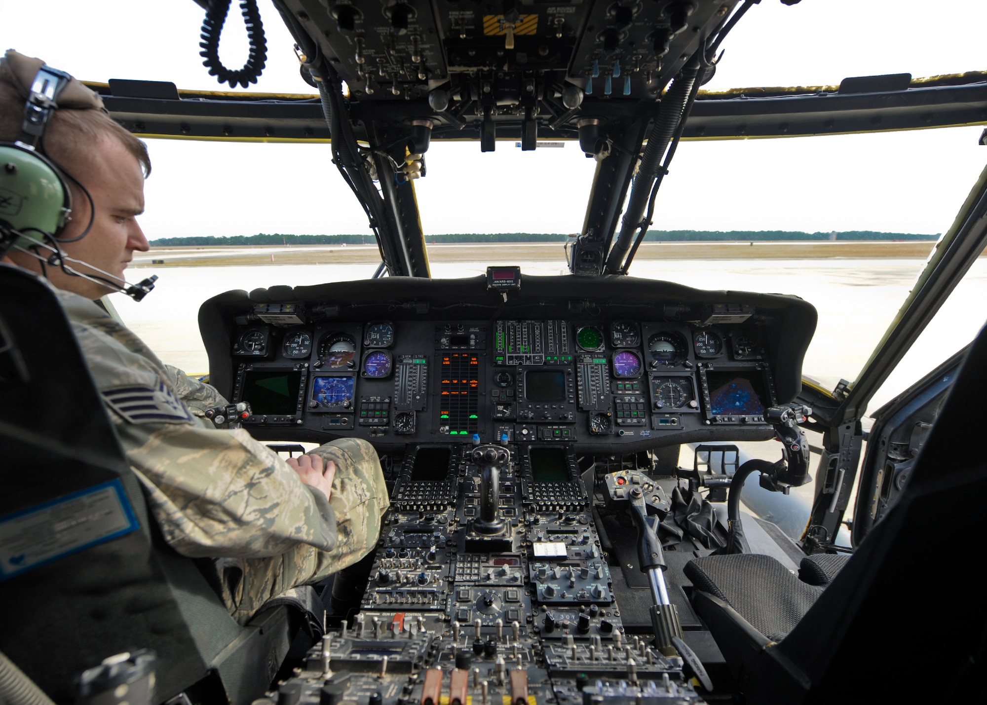 U.S. Air Force Staff Sgt. Joshua Seymour, electrical and environmental technician with the 723d Aircraft Maintenance Squadron, works in the cockpit of an HH-60G Pave Hawk to correct a hydraulic power pump issue during routine maintenance at Moody Air Force Base, Ga., Jan. 11, 2013. Airmen must inspect the complex onboard systems after every flight to ensure it is operational and mission ready.  (U.S. Air Force photo by Senior Airman Eileen Meier/Released)
