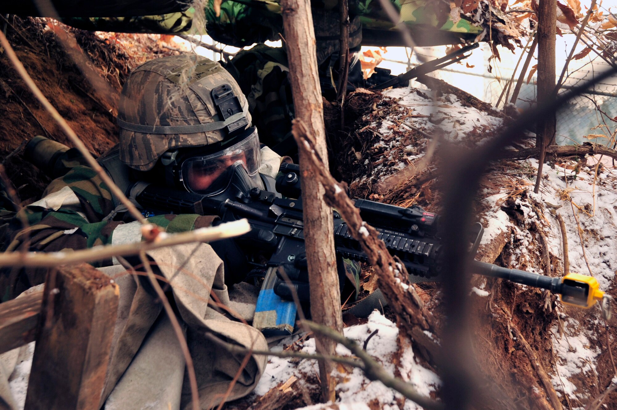 Senior Airman Prystan Viluan, 51st Security Forces Squadron defender, scans the area for opposing forces from a listening observation post during exercise Beverly Midnight 13-01 at Osan Air Base, Republic of Korea, Jan. 16, 2012. During OREs, Airmen highlight their ability to position, employ, and sustain forces and showcase operational readiness. BM 13-01 is the first ORE of the 2013. (U.S. Air Force photo/Airman 1st Class Alexis Siekert)