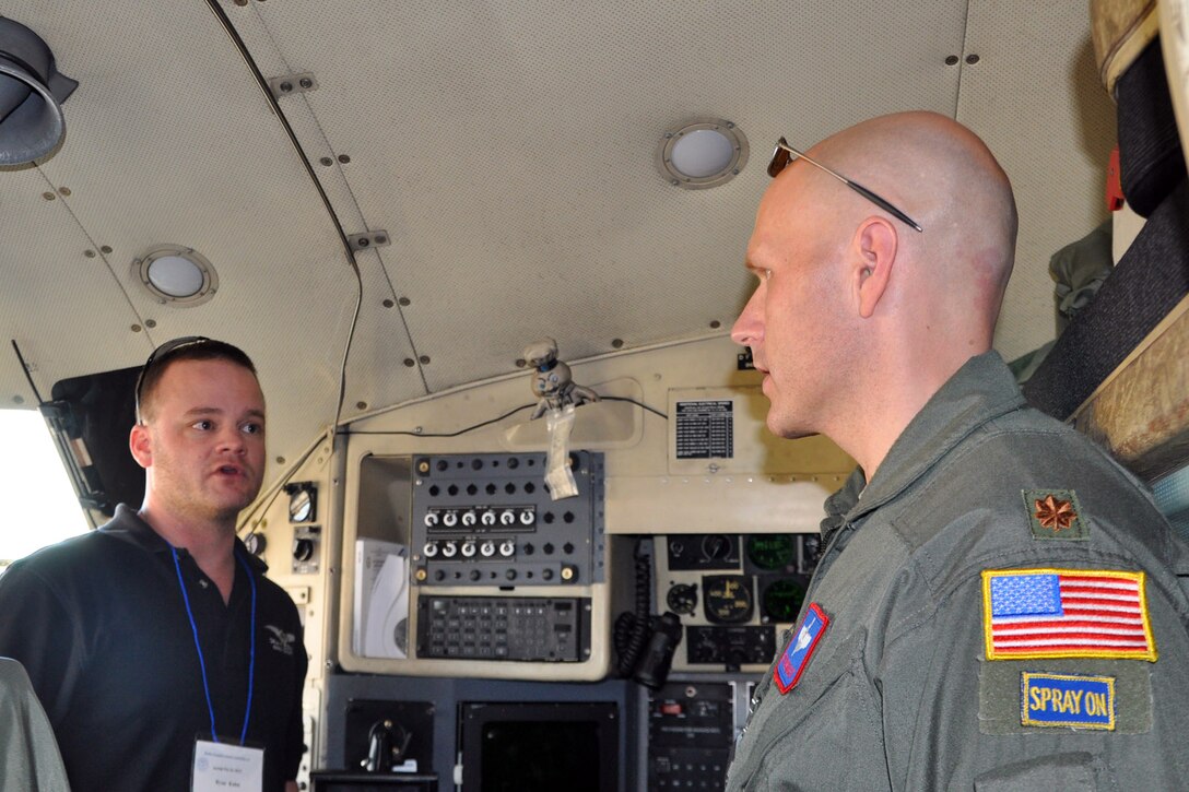 U.S. Air Force Reserve Maj. Pat Fassnacht (right), an aerial-spray qualified pilot, assigned to the 910th Airlift Wing’s 757th Airlift Squadron, talks with a participant of the Department of Defense Aerial Spray Course on the flight deck of one of the wing’s specially-modified, aerial spray capable C-130 aircraft on the flightline at Page Field, Fla., Jan. 15, 2013. The static display of the aircraft and aerial spray equipment was part of the course, which is a certification requirement for pest management specialists involved in the aerial spraying of products designed to destroy disease-carrying creatures. Members of the 910th’s highly-trained aerial spray team, based at Youngstown Air Reserve Station, Ohio, were on hand to answer questions about the aircraft, equipment or the unit’s mission. The 910th is home to DoD’s only aerial spray mission and the team brought their unique knowledge to the course for the benefit of those participating in the event. U.S. Air Force photo by Master Sgt. Bob Barko Jr. 