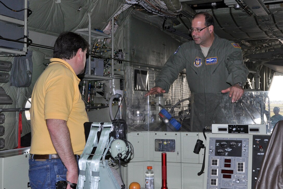 U.S. Air Force Reserve Chief Master Sgt. Don Cutrer (right), a loadmaster and aerial spray system operator assigned to the 910th Airlift Wing’s 757th Airlift Squadron, talks with a participant of the Department of Defense Aerial Spray Course on the cargo deck of one of the 910th’s specially-modified, aerial spray capable C-130 aircraft on the flightline at Page Field, Fla., Jan. 15, 2013. The static display of the aircraft and aerial spray equipment was part of the course, which is a certification requirement for pest management specialists involved in the aerial spraying of products designed to destroy disease-carrying creatures. Members of the 910th’s highly-trained aerial spray team, based at Youngstown Air Reserve Station, Ohio, were on hand to answer questions about the aircraft, equipment and the unit’s mission. The 910th is home to DoD’s only aerial spray mission and the team brought their unique knowledge to the course for the benefit of those participating in the event. U.S. Air Force photo by Master Sgt. Bob Barko Jr.
