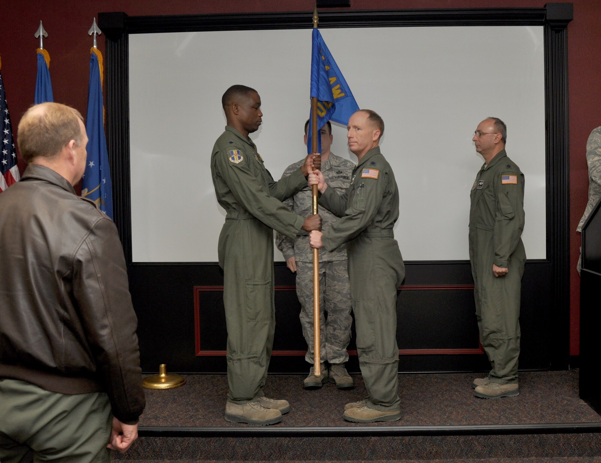 Lt. Col. Timothy Miller, 914th Operations Support Squadron (middle right), receives the standard of the 914 OSS from Lt. Col. Patrick Campbell, 914th Operations Group Deputy Commander, during a Change of Command ceremony January 5, 2013 at the Niagara Falls Air Reserve Station, N.Y.  Lt. Col. Miller replaces Lt. Col. Anthony Butera (far right).  (U.S. Air Force photo by Staff Sgt. Stephanie Clark)