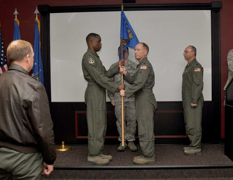 Lt. Col. Timothy Miller, 914th Operations Support Squadron (middle right), receives the standard of the 914 OSS from Lt. Col. Patrick Campbell, 914th Operations Group Deputy Commander, during a Change of Command ceremony January 5, 2013 at the Niagara Falls Air Reserve Station, N.Y.  Lt. Col. Miller replaces Lt. Col. Anthony Butera (far right).  (U.S. Air Force photo by Staff Sgt. Stephanie Clark)