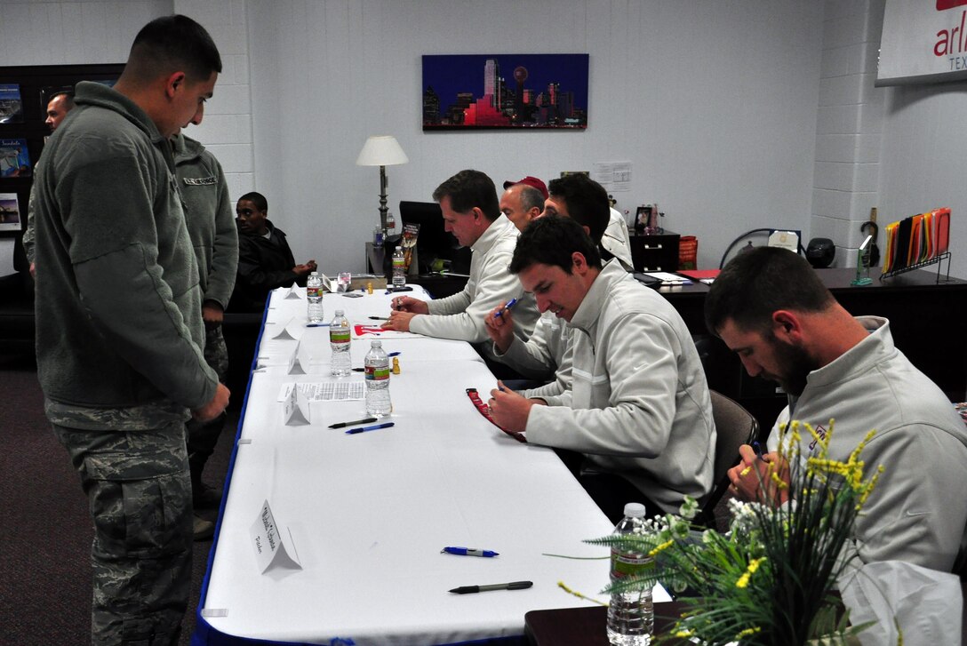 Members of the Texas Rangers pitching, coaching and radio broadcasting staff sign autographs at Sheppard Air Force Base January 15, 2013.  The Rangers’ visited the base as part of their annual Winter Caravan Tour.  (U.S. Air Force Photo/Josh Wilson)