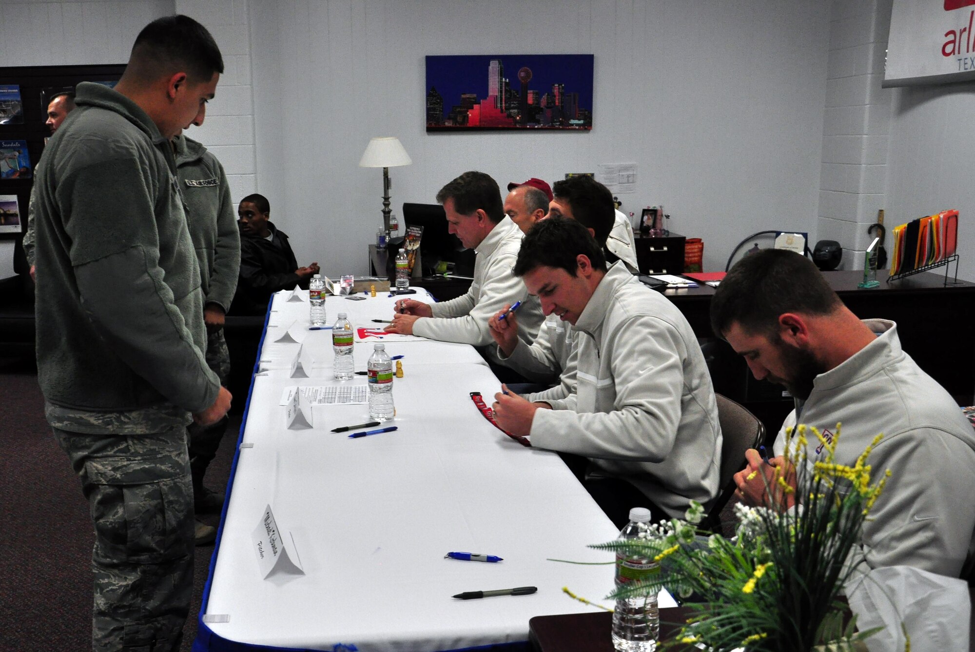 Members of the Texas Rangers pitching, coaching and radio broadcasting staff sign autographs at Sheppard Air Force Base January 15, 2013.  The Rangers’ visited the base as part of their annual Winter Caravan Tour.  (U.S. Air Force Photo/Josh Wilson)