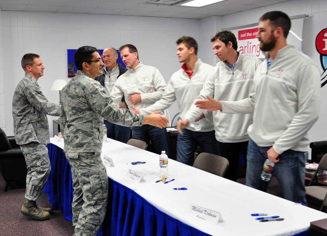 Col. Om Prakash, 82 TRW Vice-Commander, and Maj. Darin Boesiger, 82 TRW Director of Staff, welcome members of the Texas Rangers pitching, coaching and radio broadcasting staff who visited Sheppard Air Force Base January 15, 2013.  The Rangers’ visit was part of their annual Winter Caravan Tour.  (U.S. Air Force Photo/Josh Wilson)