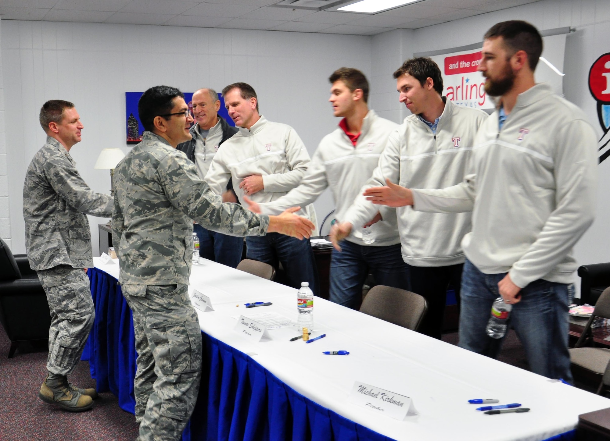 Col. Om Prakash, 82 TRW Vice-Commander, and Maj. Darin Boesiger, 82 TRW Director of Staff, welcome members of the Texas Rangers pitching, coaching and radio broadcasting staff who visited Sheppard Air Force Base January 15, 2013.  The Rangers’ visit was part of their annual Winter Caravan Tour.  (U.S. Air Force Photo/Josh Wilson)