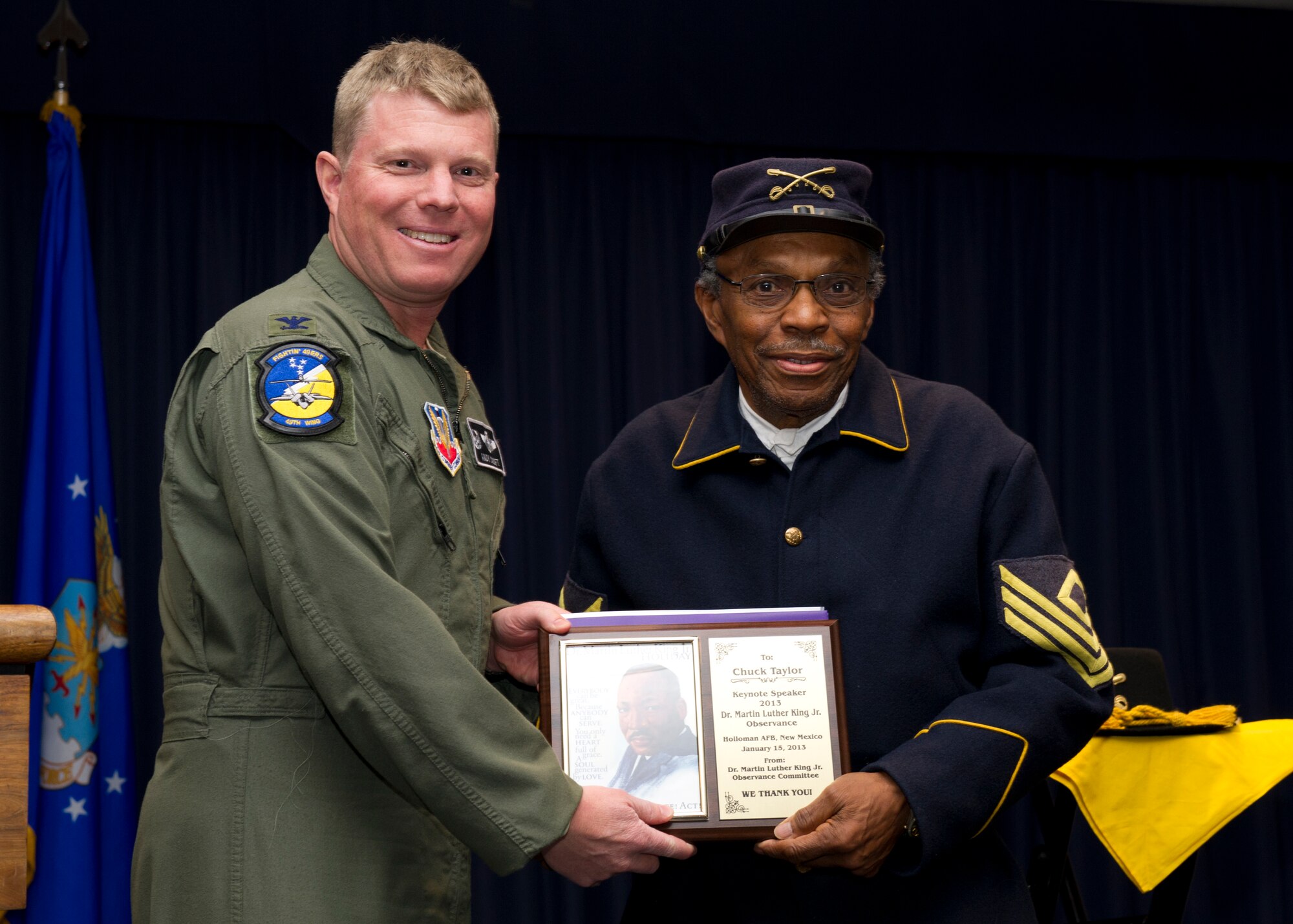 Colonel Andrew Croft, 49th Wing commander, presents a certificate of appreciation to retired Army Command Sgt. Maj. Charles Taylor Jr., Buffalo Soldier reenactor, El Paso, Texas, for speaking at the Dr. Martin Luther King Jr. Remembrance Day Luncheon at Holloman Air Force Base, N.M., Jan. 15. Holloman AFB personnel came to the luncheon to celebrate and reflect on Dr. King’s life and his contributions to the nation. (U.S. Air Force photo by Senior Airman Kasey Close/Released)