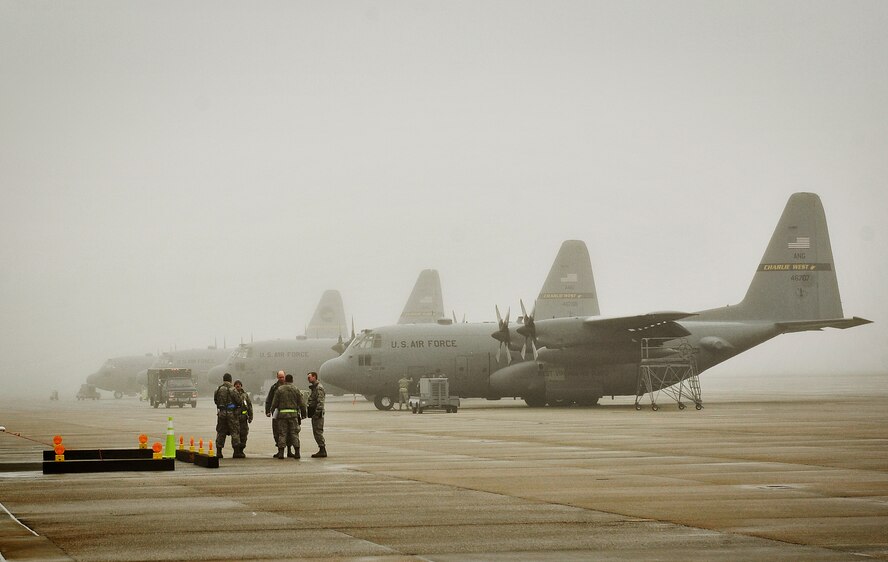 Crew chiefs from the 130th Airlift Wing prepare C-130s to take off during an Operational Readiness Exercise at the Mississippi Air National Guard's Combat Readiness Training Center Gulfport in Gulfport, Miss. Jan. 15, 2013. The 134th AEW is comprised of four units: the 153rd Airlift Wing, the 130th Airlift Wing, the 375th Air Mobility Wing and the 11th Wing. The exercise assesses the abilities of the individual units to deploy forces, quickly respond and recover assets during a week-long exercise conducted and graded by an Exercise Evaluation (U.S. Air Force photo/ Staff Sgt. Ryan Crane)