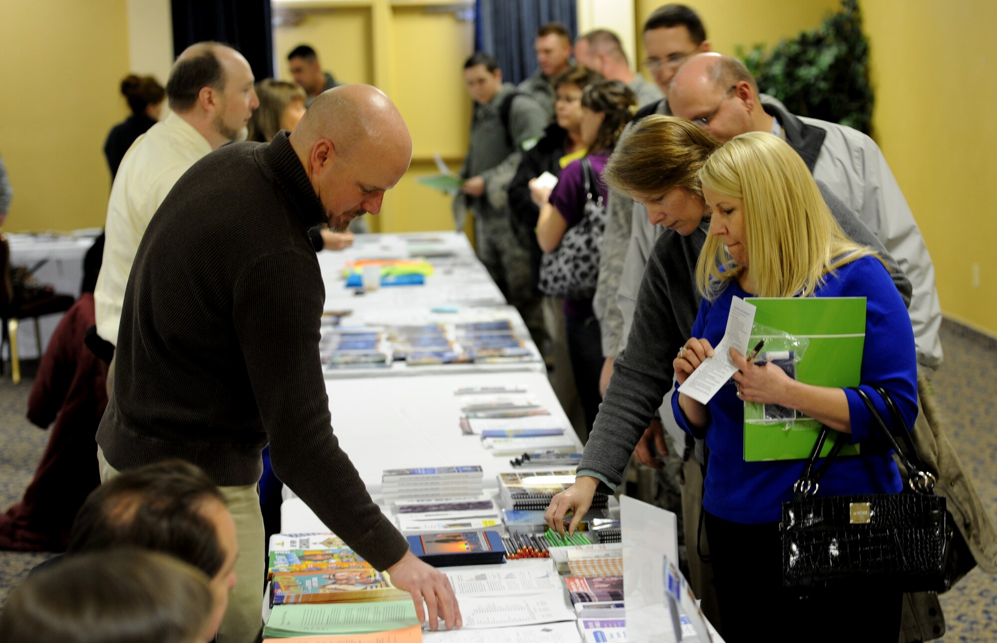 Chad Canaan, 28th Force Support Squadron school liaison officer, provides information about school systems in the surrounding area to Airmen and their families during Happy Landings in the Dakota’s Club at Ellsworth Air Force Base, S.D., Jan. 15, 2013. Happy Landings, a monthly fair for both newcomers to Ellsworth and those who’ve been around for a while, gave those who attended a crash course on all the services Ellsworth has to offer. (U.S. Air Force photo by Airman 1st Class Hrair H. Palyan/Released)