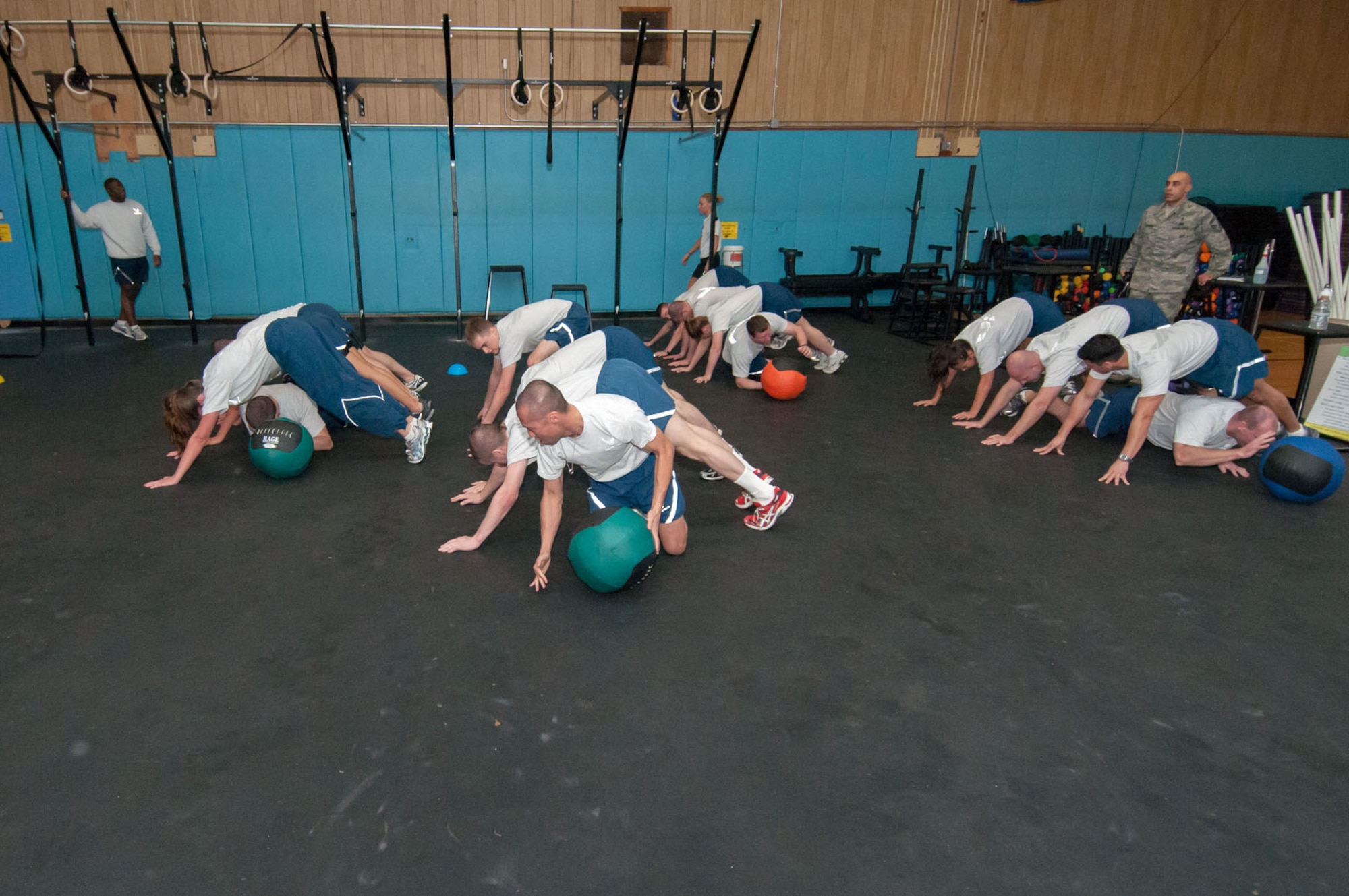 HANSCOM AIR FORCE BASE, Mass. –Teams compete in the medicine ball low crawl during a Warrior Day activity Jan. 9 at the Fitness and Sports Center. Warrior Day allows Airmen to experience intense physical activity while working with teammates to achieve goals. (U.S. Air Force photo by Rick Berry)